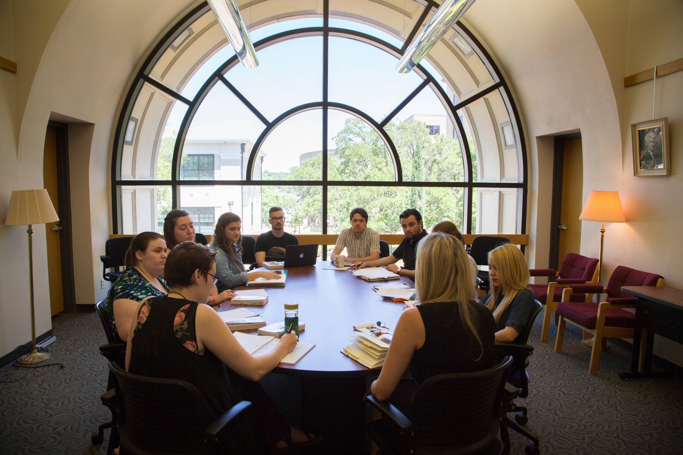 An image of graduate students in the Flowers Hall conference room