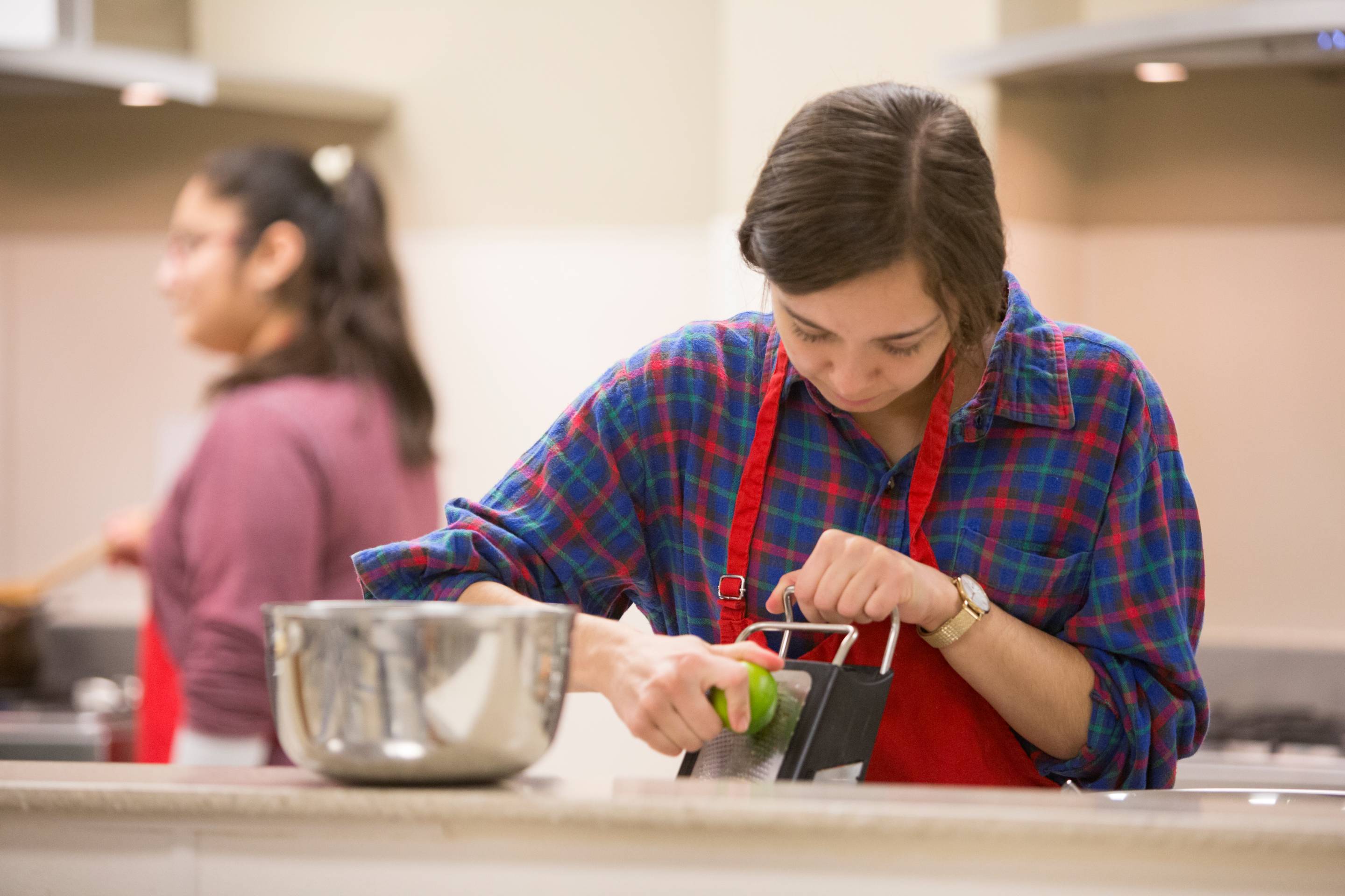 student using food grater