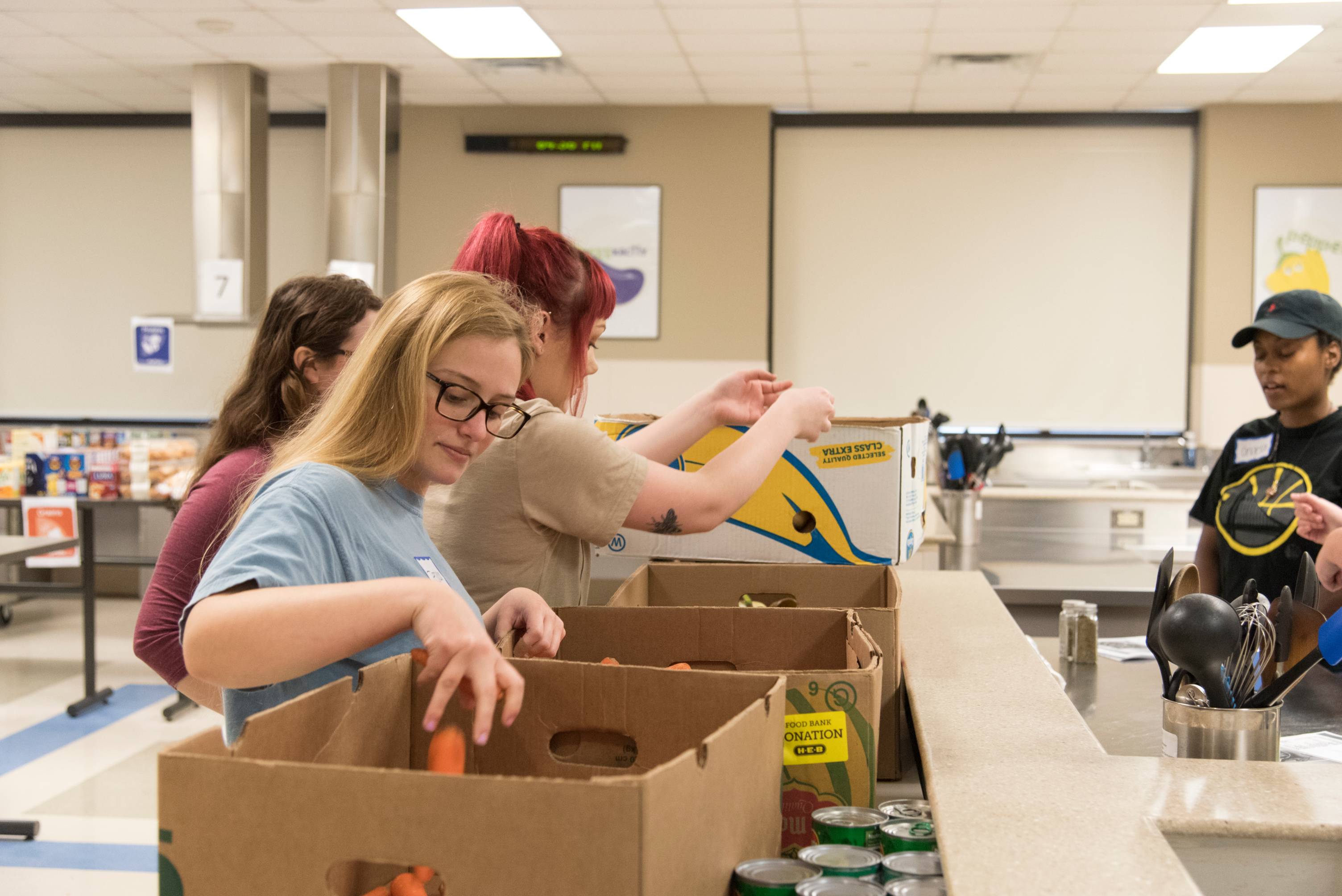 student packing food in boxes