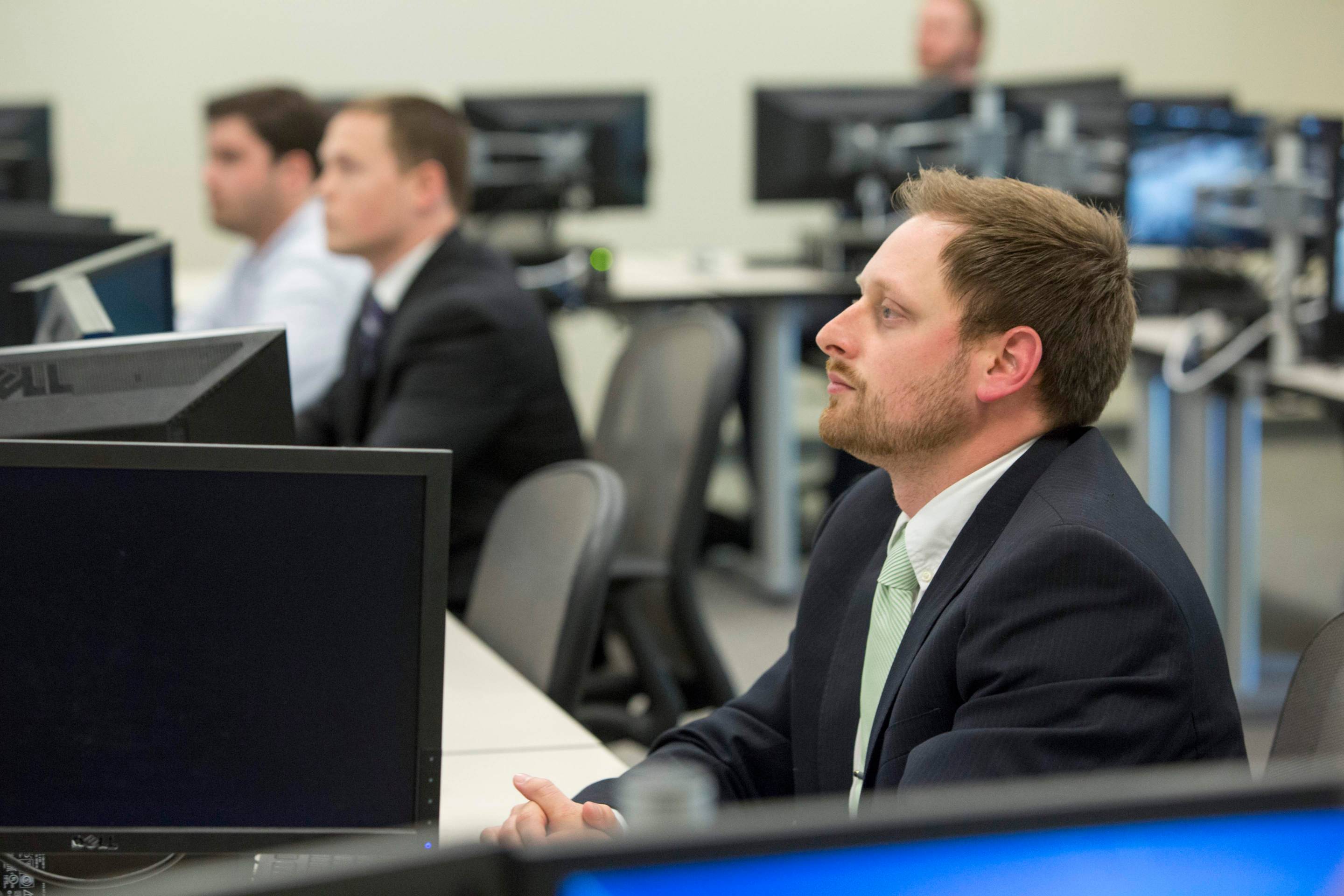 student looking at front of the classroom in the Trading Lab