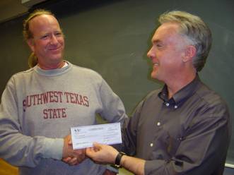 Jack Kinslow receiving scholarship check from Center for Texas Music History director Gary Hartman.
