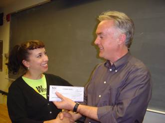 Dee Lannon receiving scholarship check from Center for Texas Music History director Gary Hartman.