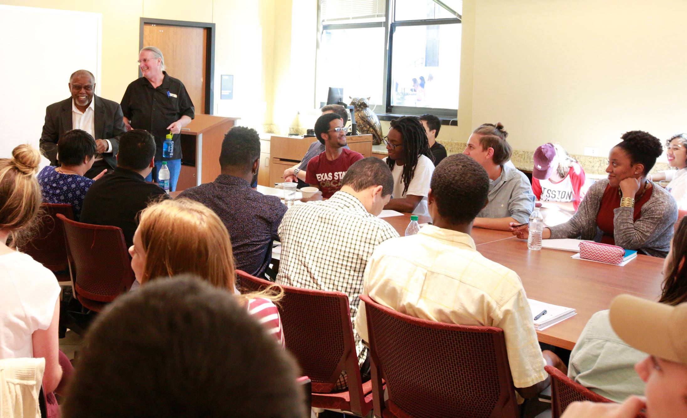 conference table surrounded by students