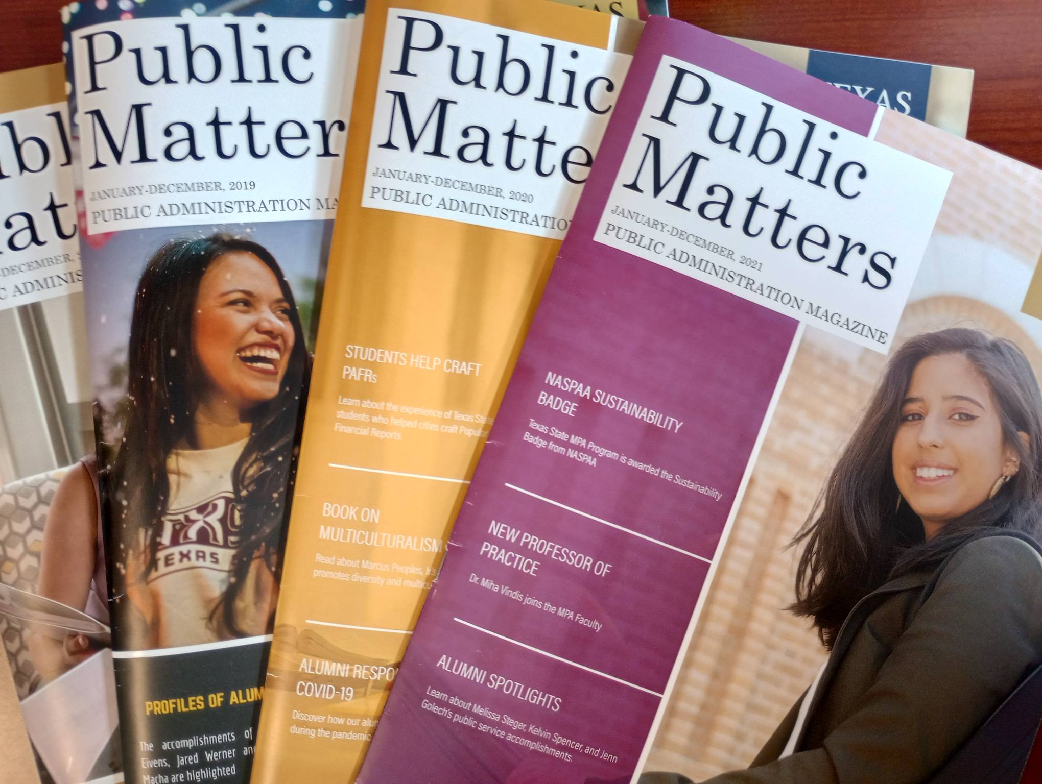 4 issues of Public Matters spread out across a table
