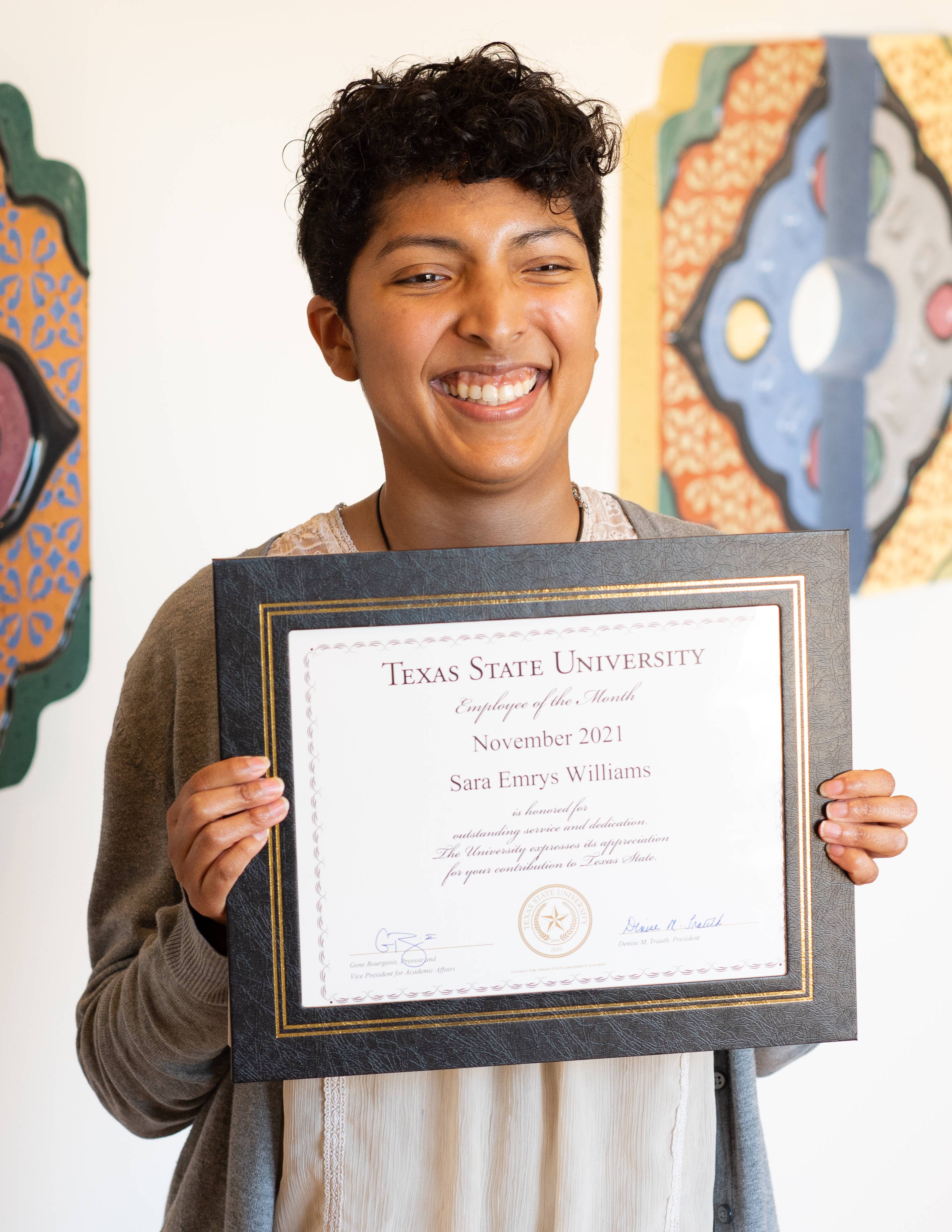 an image of Emrys holding her award