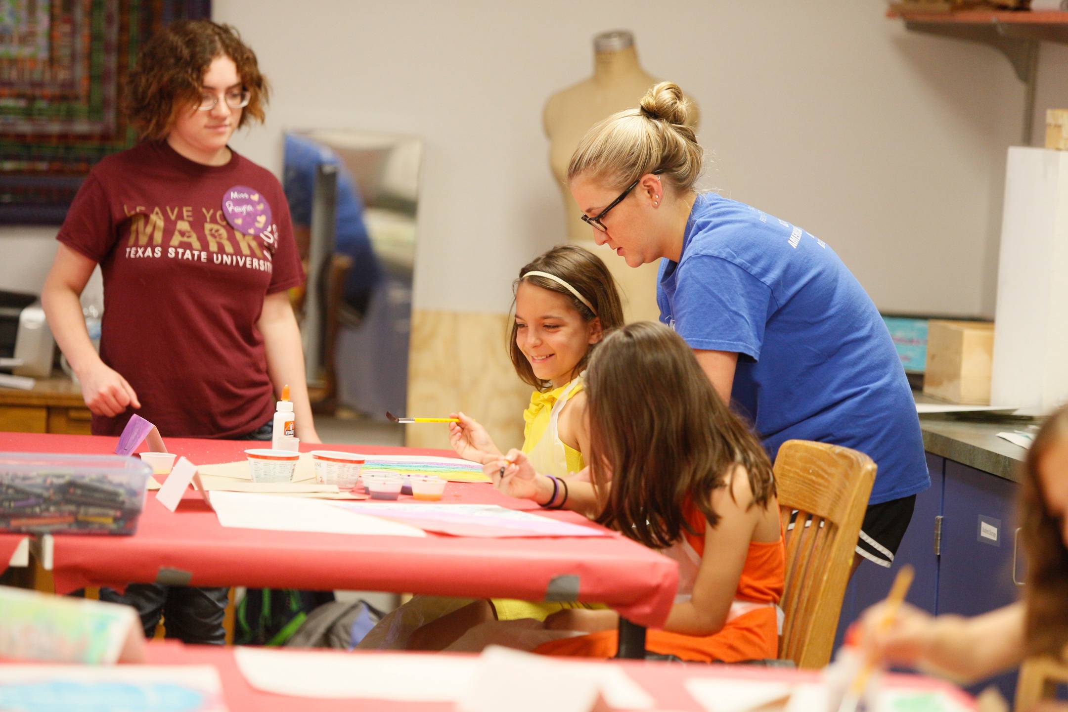 teacher with students at a table