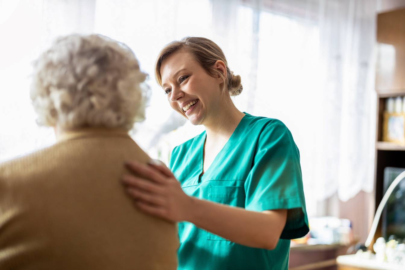 Nurse assisting an elderly patient