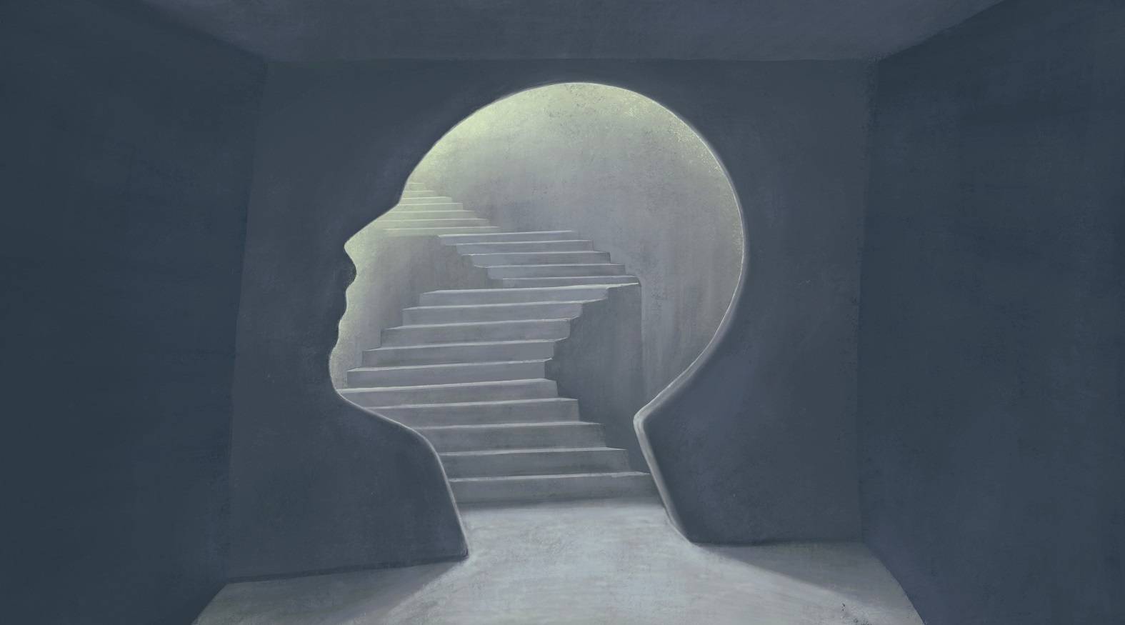 A wall in the shape of a head with stairs inside the cutout.