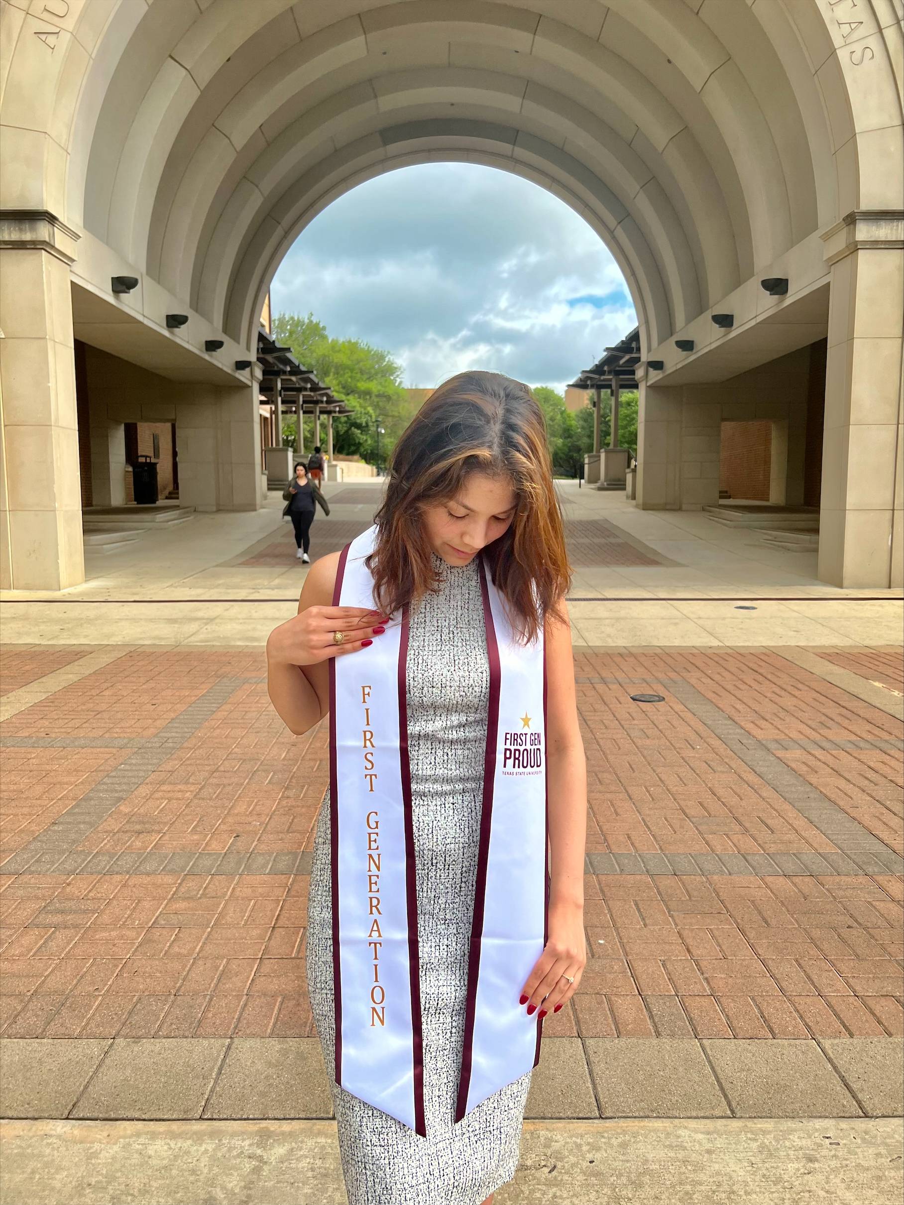 The image displays a first generation student wearing a stole