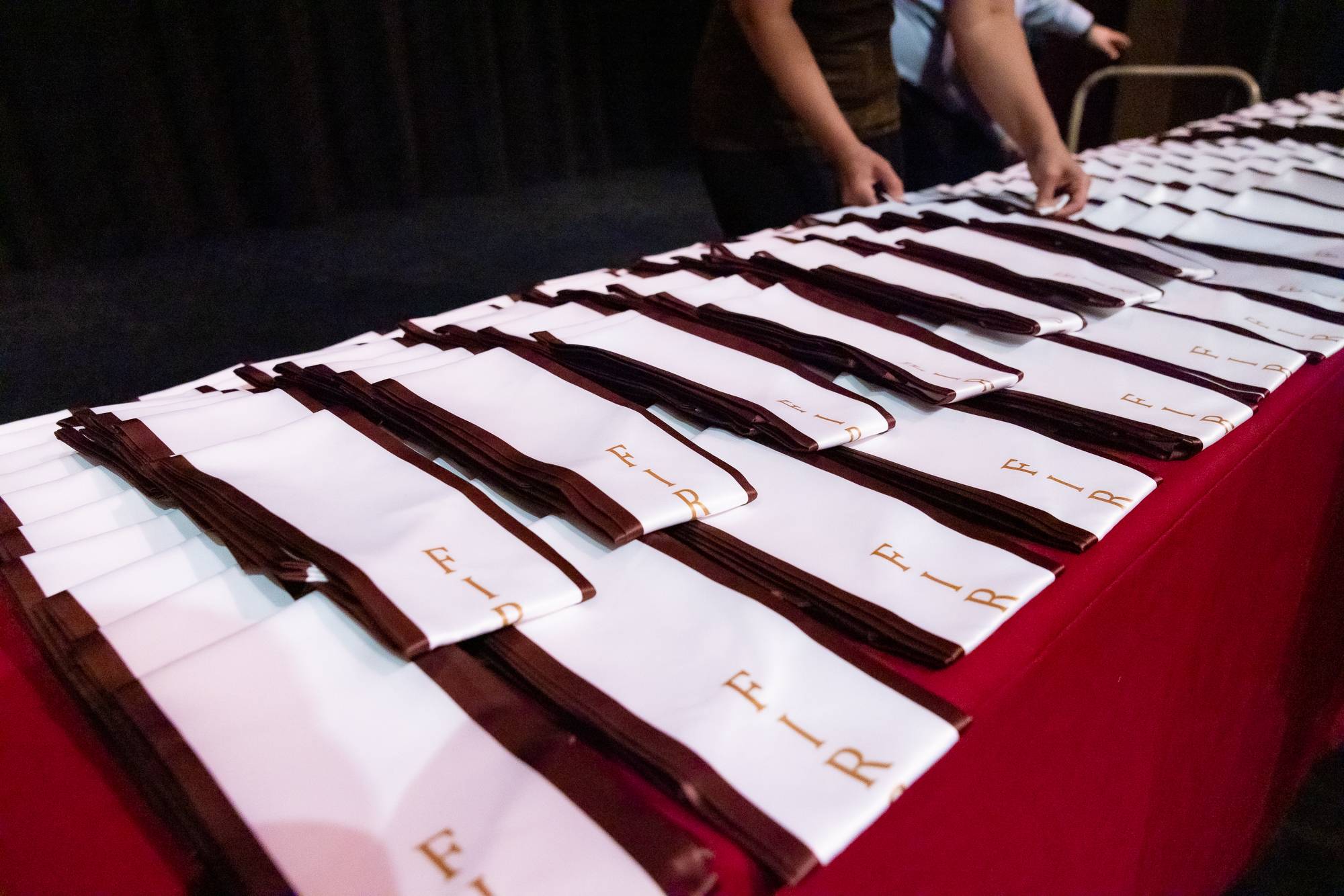 First generation graduation stoles arranged for display on a table.