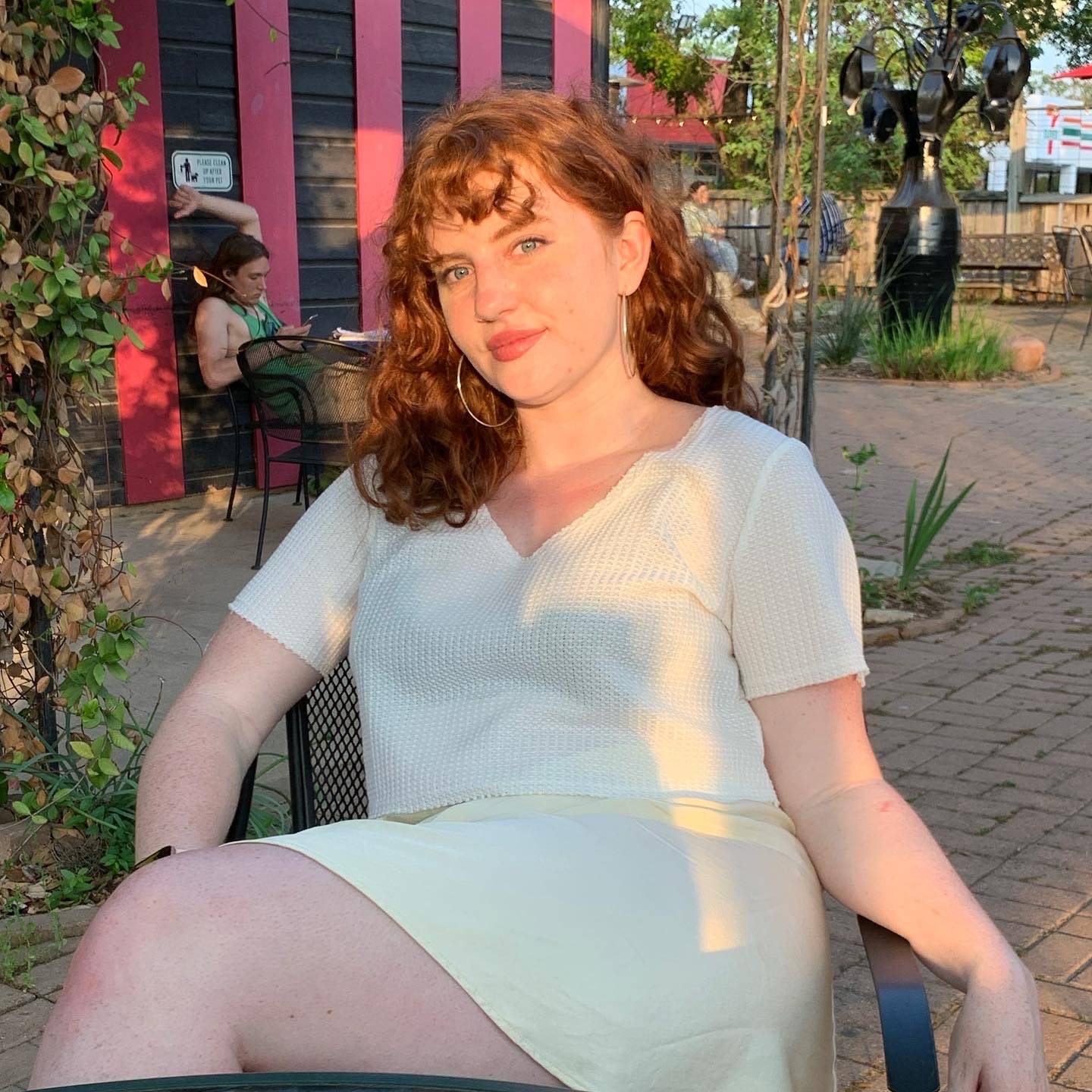 woman sitting on chair at outdoor café