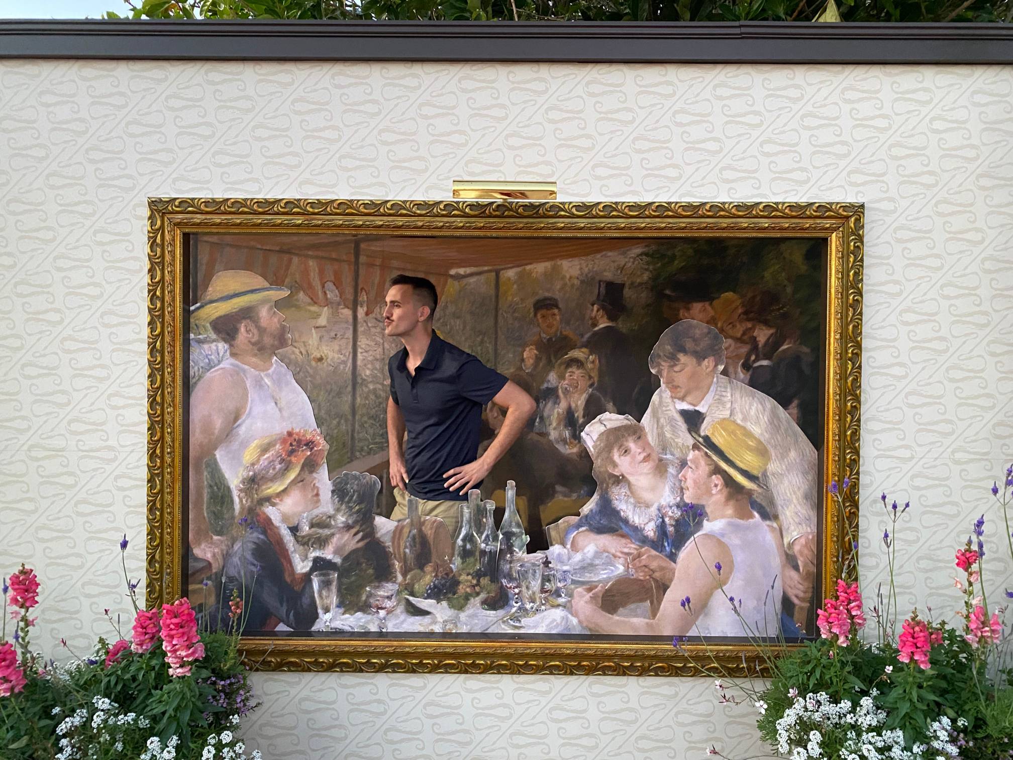 Man wearing blue shirt inserted into Renoir's painting "Luncheon of the Boating Party"