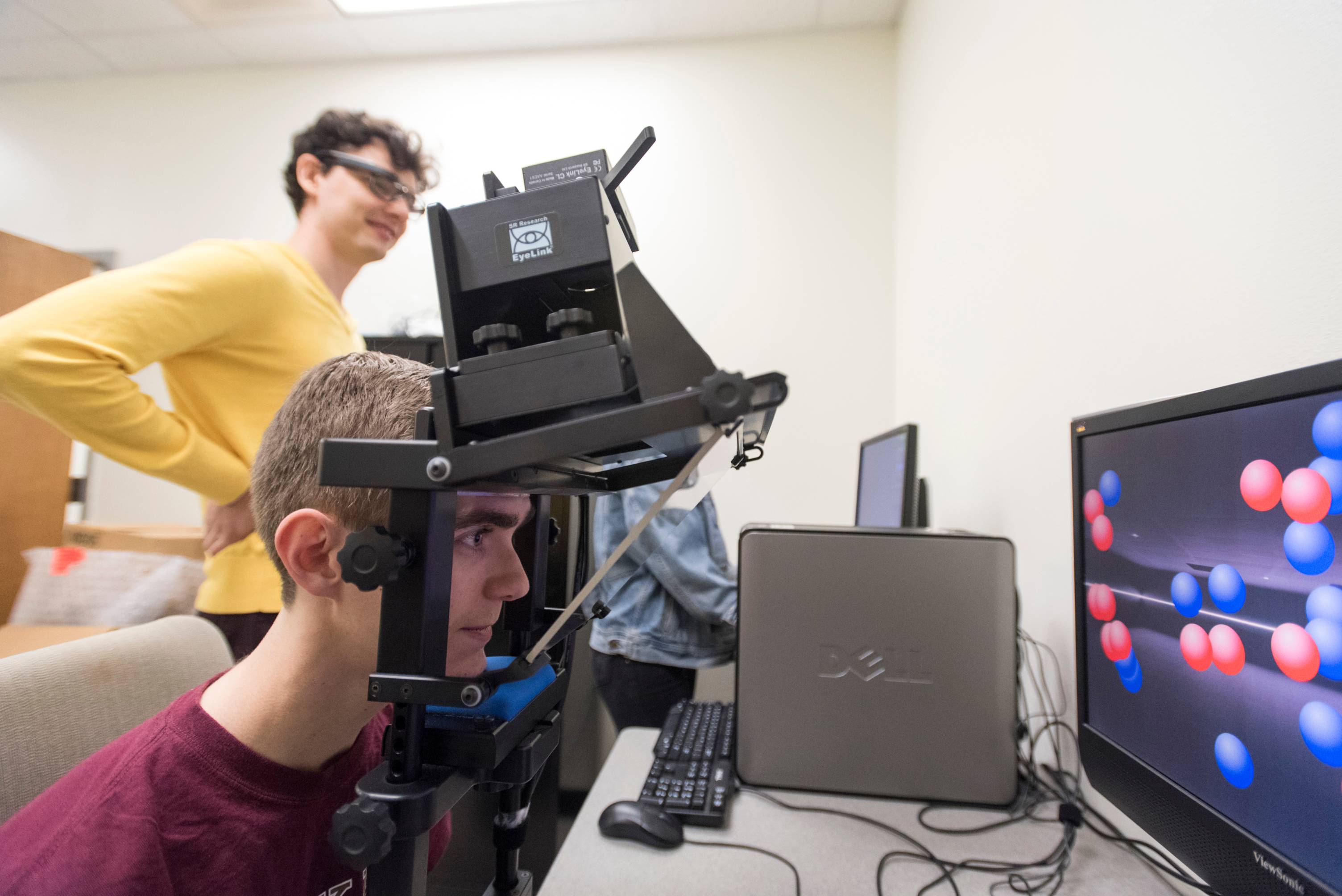 student wearing headgear for eye tracking technology
