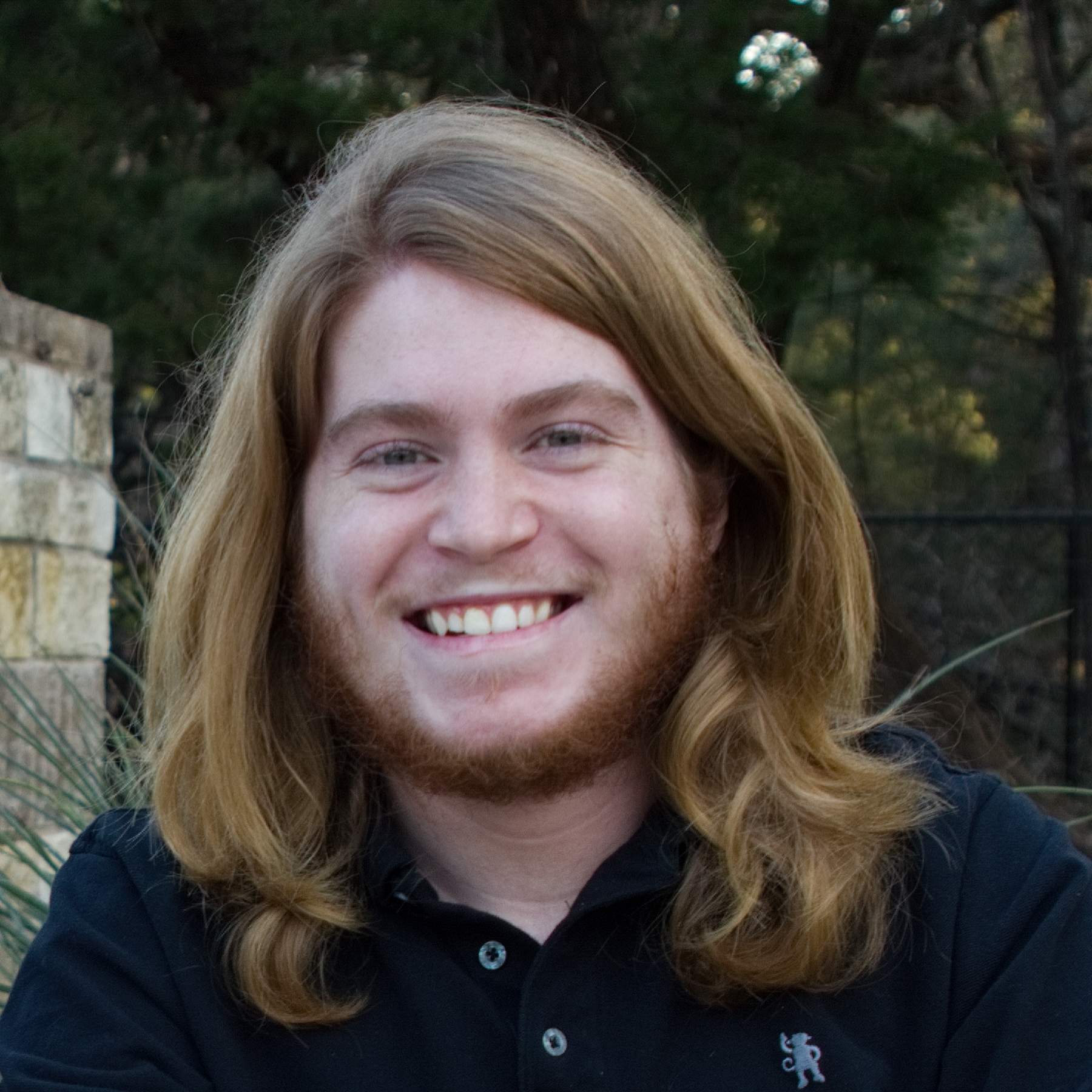 Man with long hair smiling
