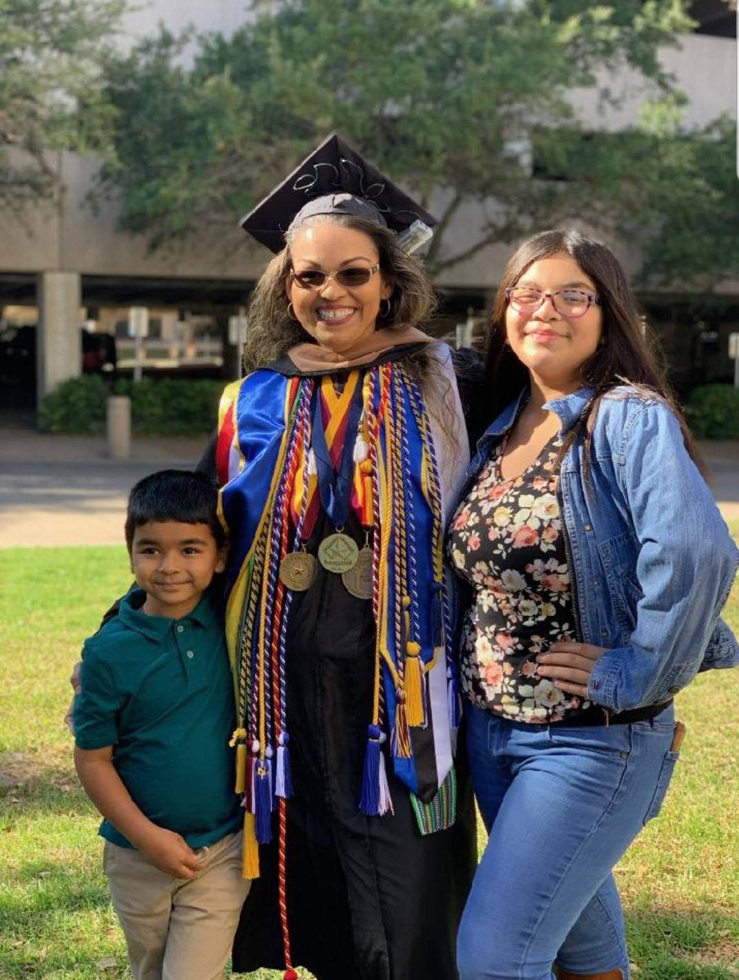 Jessica Ramos-Karmaker with her family after a commencement ceremony
