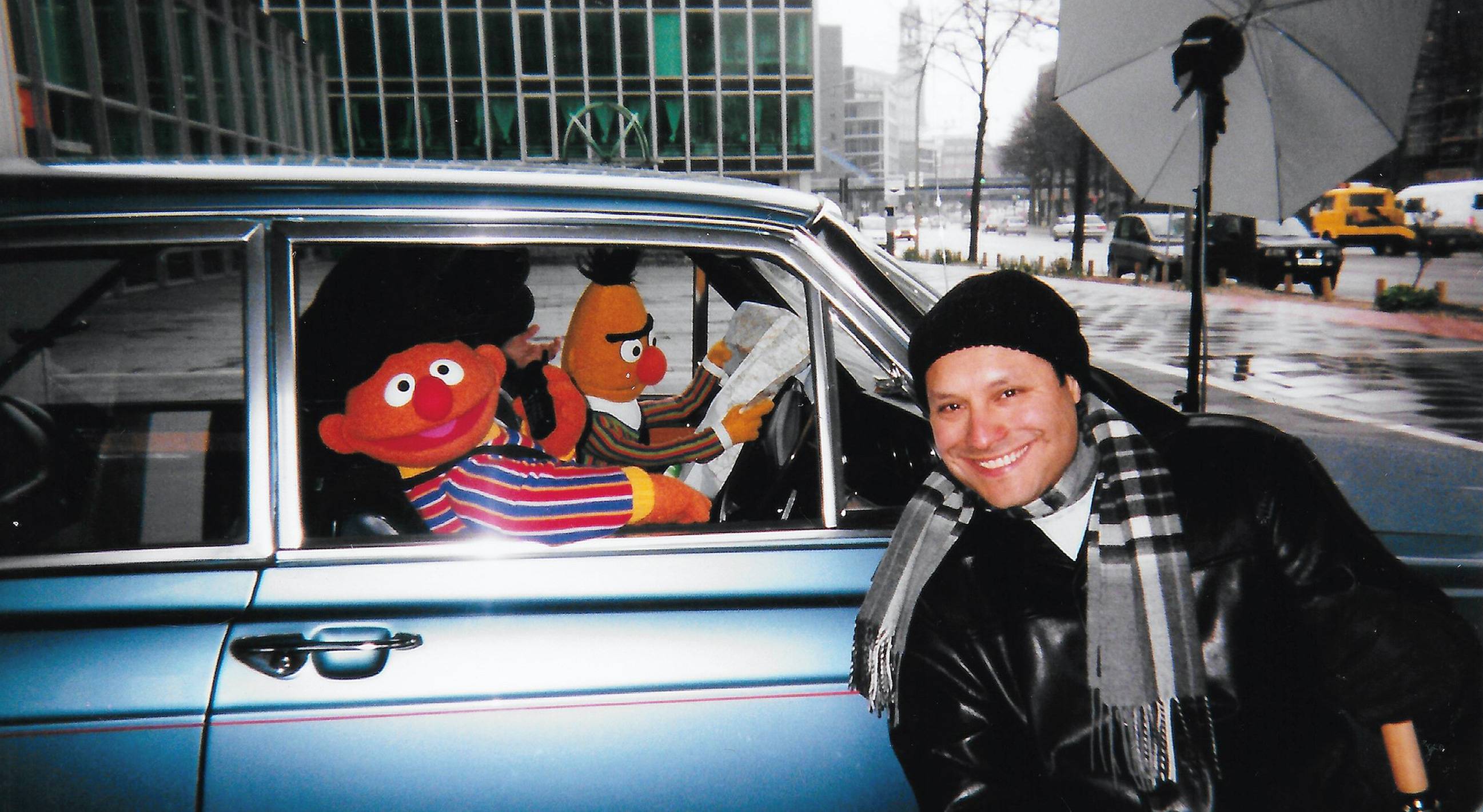 roger estrada next to car with muppet characters in it