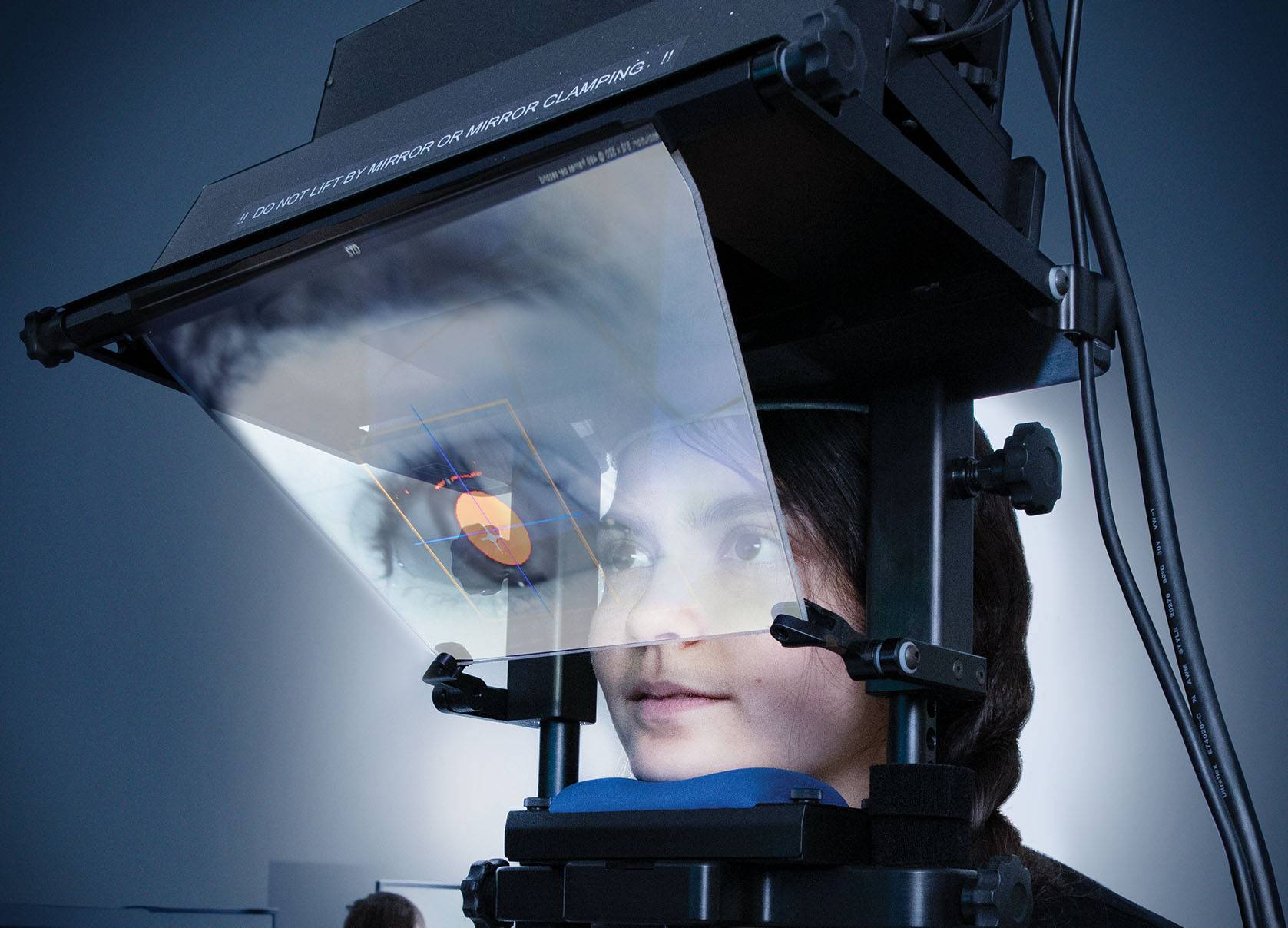 person having their eye scanned in machine