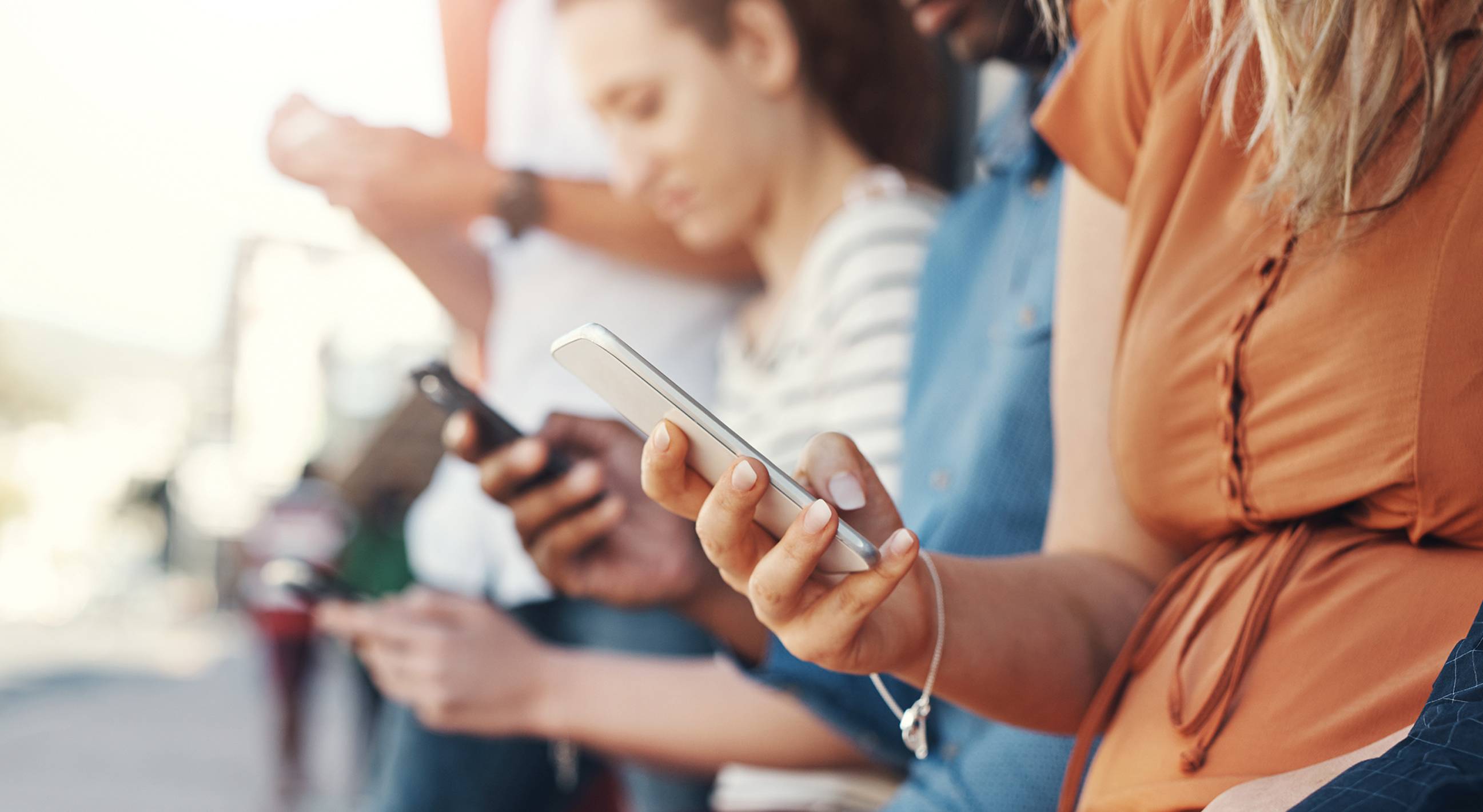 group of people looking at their smartphones