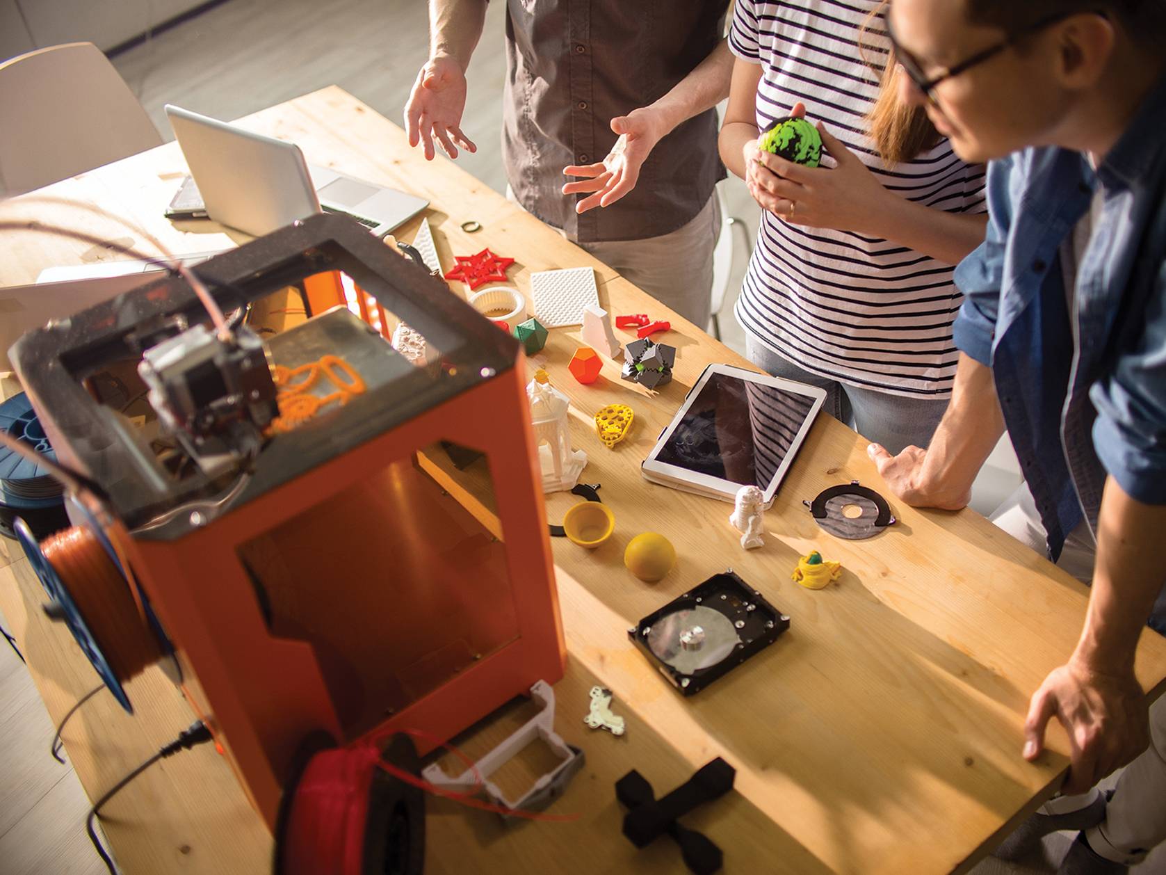 group of people working on 3D printer