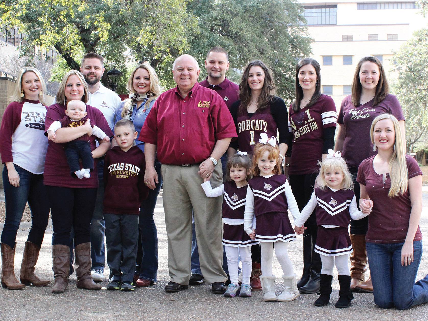 Family decked out in Bobcat gear stands in the quad