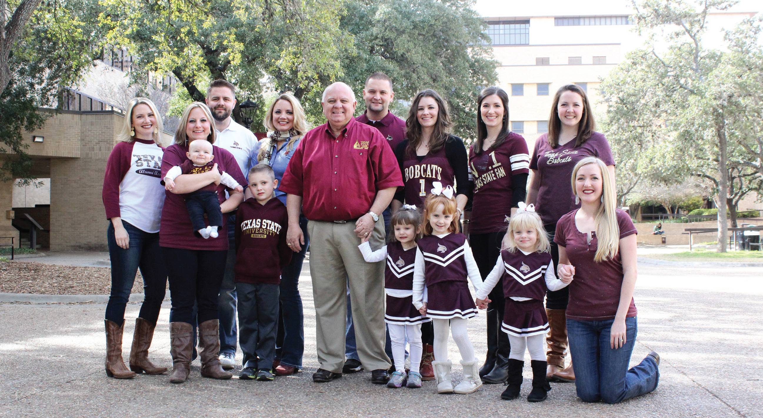 family dressed in bobcat gear on campus