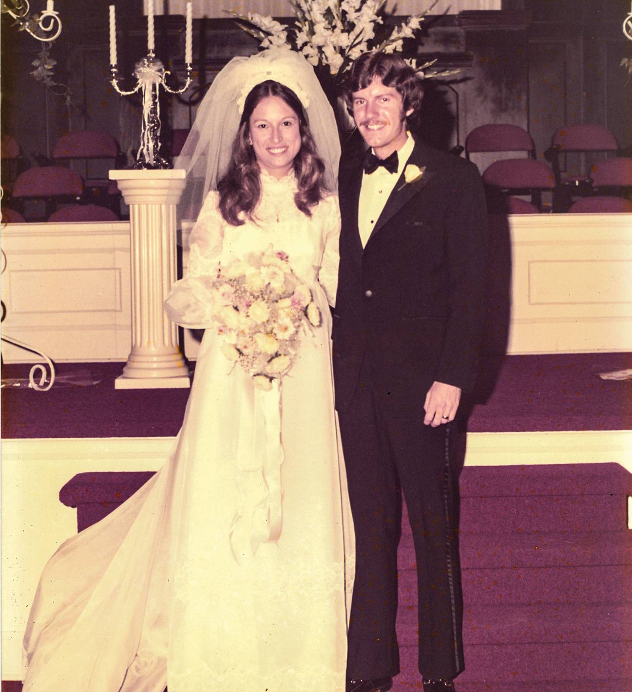 couple smiling in wedding outfits