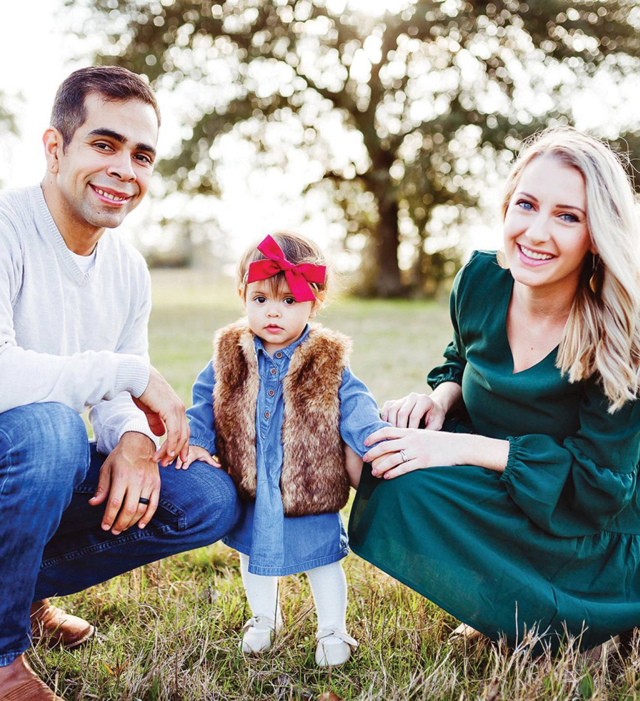 couple smiling with young child