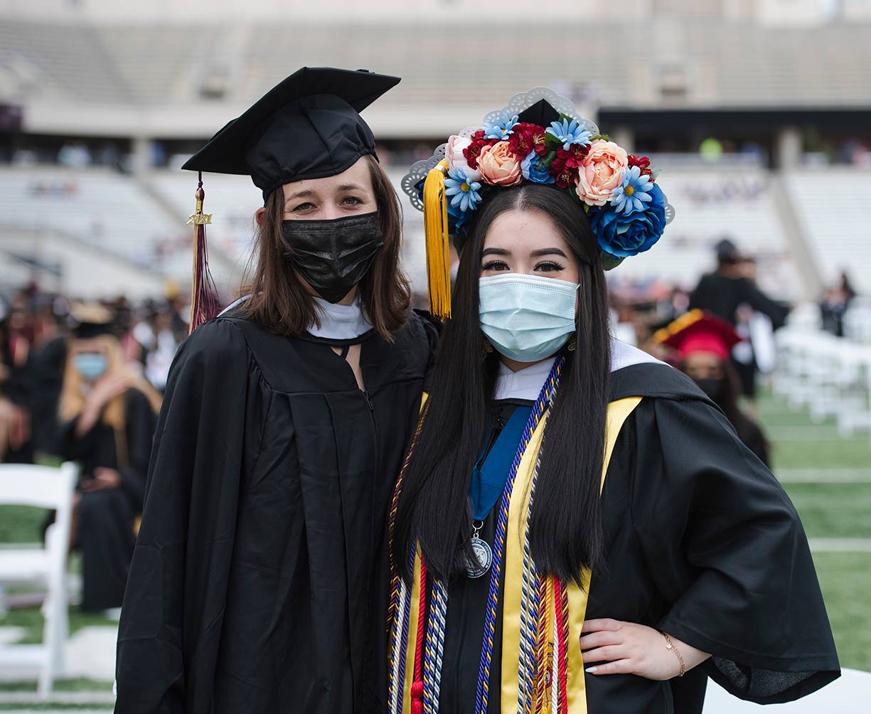 two female graduates smiling for photo