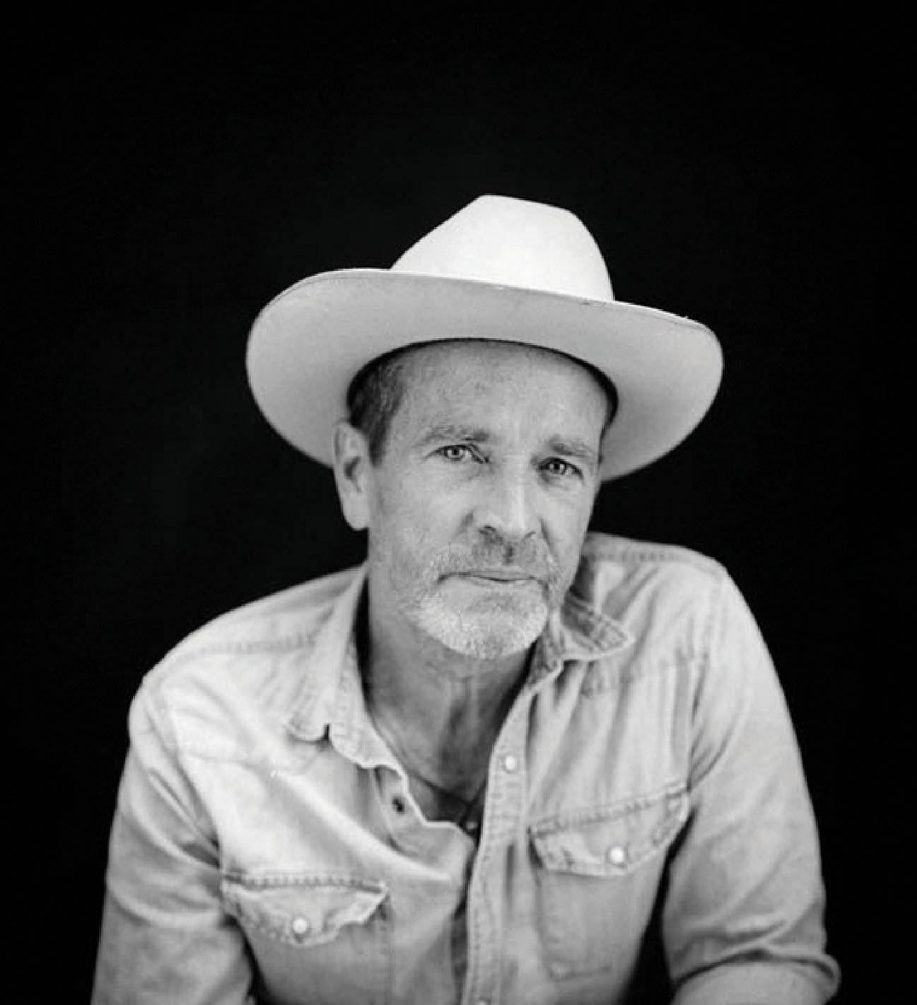 black and white photo of man in cowboy hat