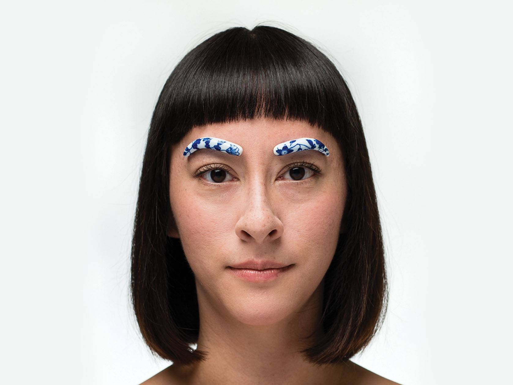 headshot of woman with porcelain pieces of eyebrows