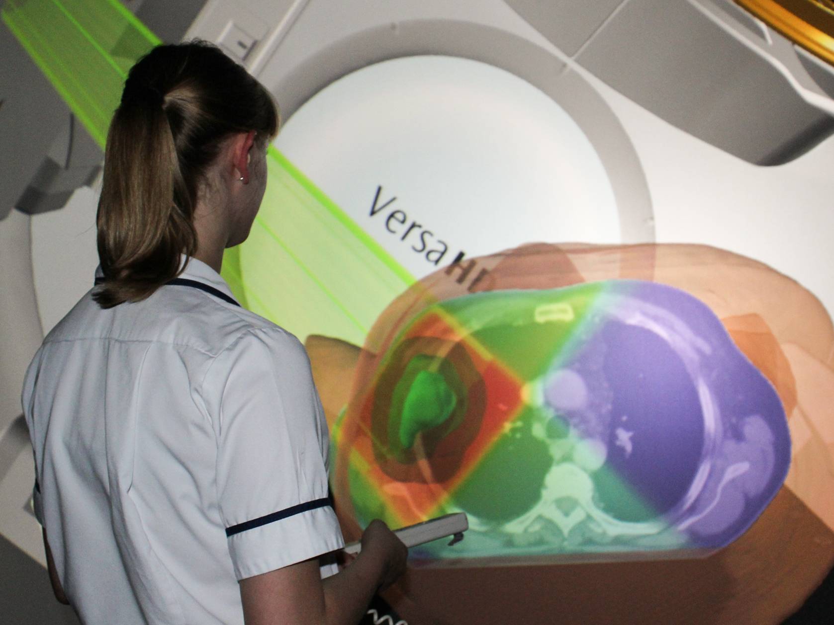 student looking at 3D model of radiation treatment
