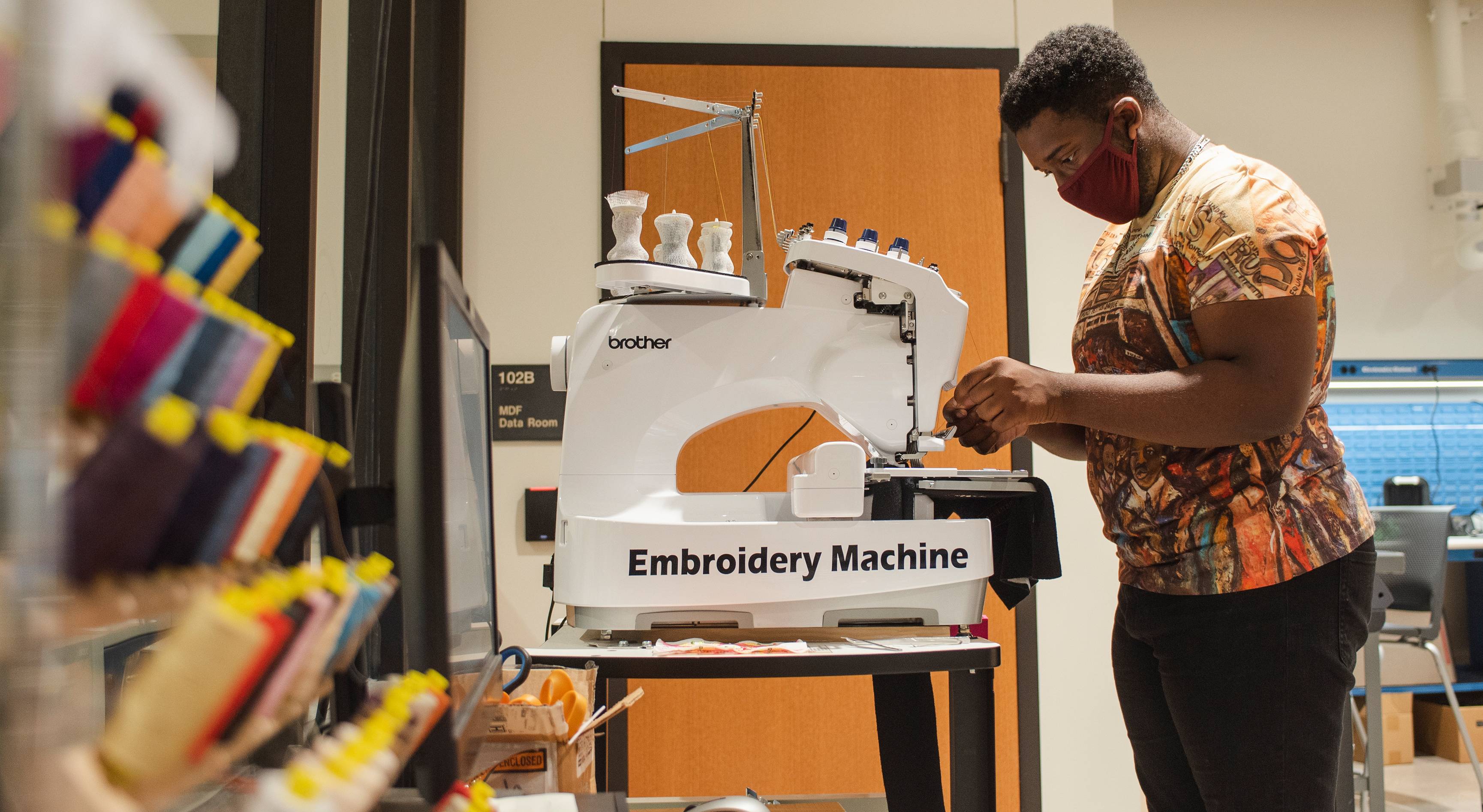 man using embroidery machine