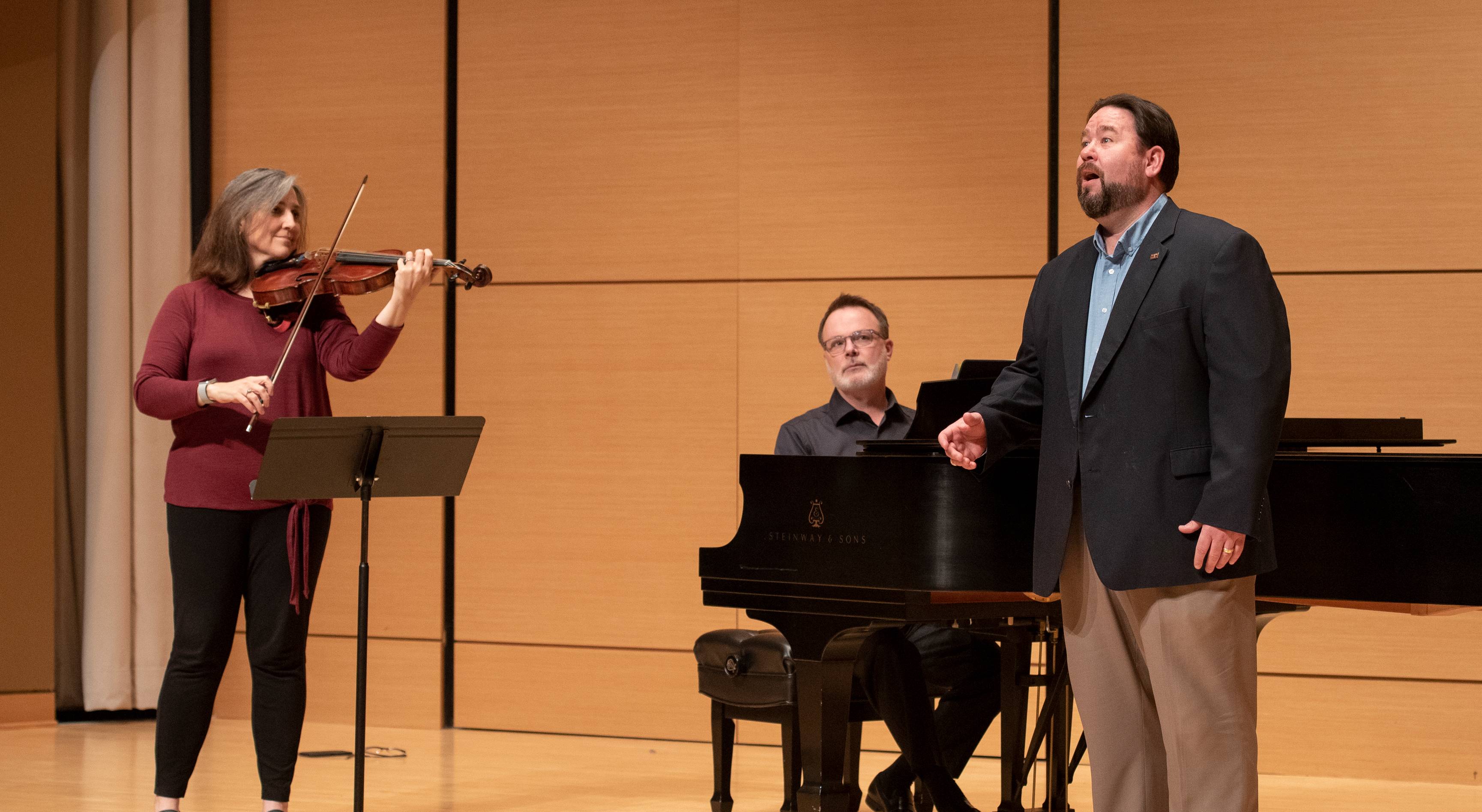 three performers on stage