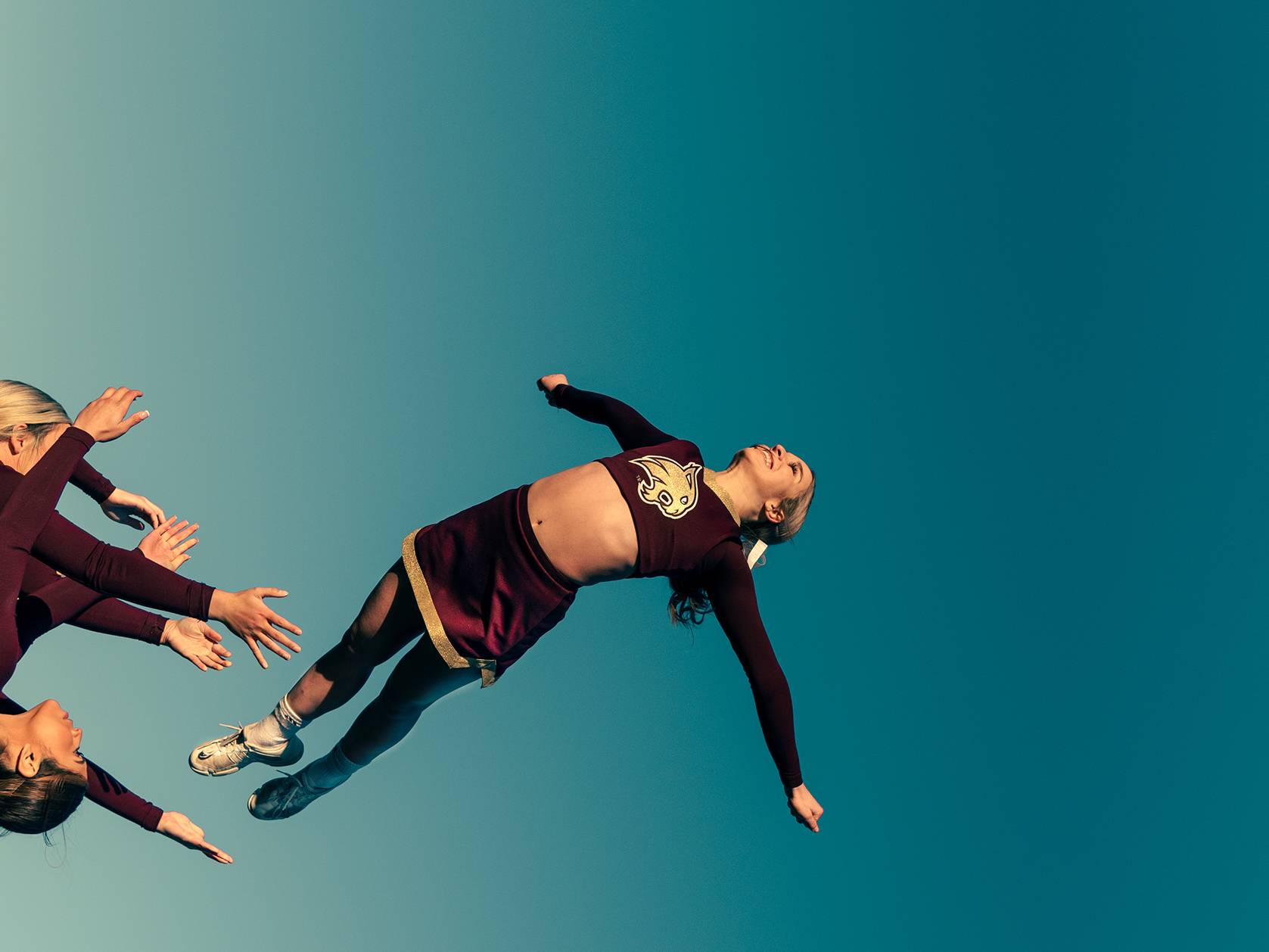 cheerleader being thrown in air