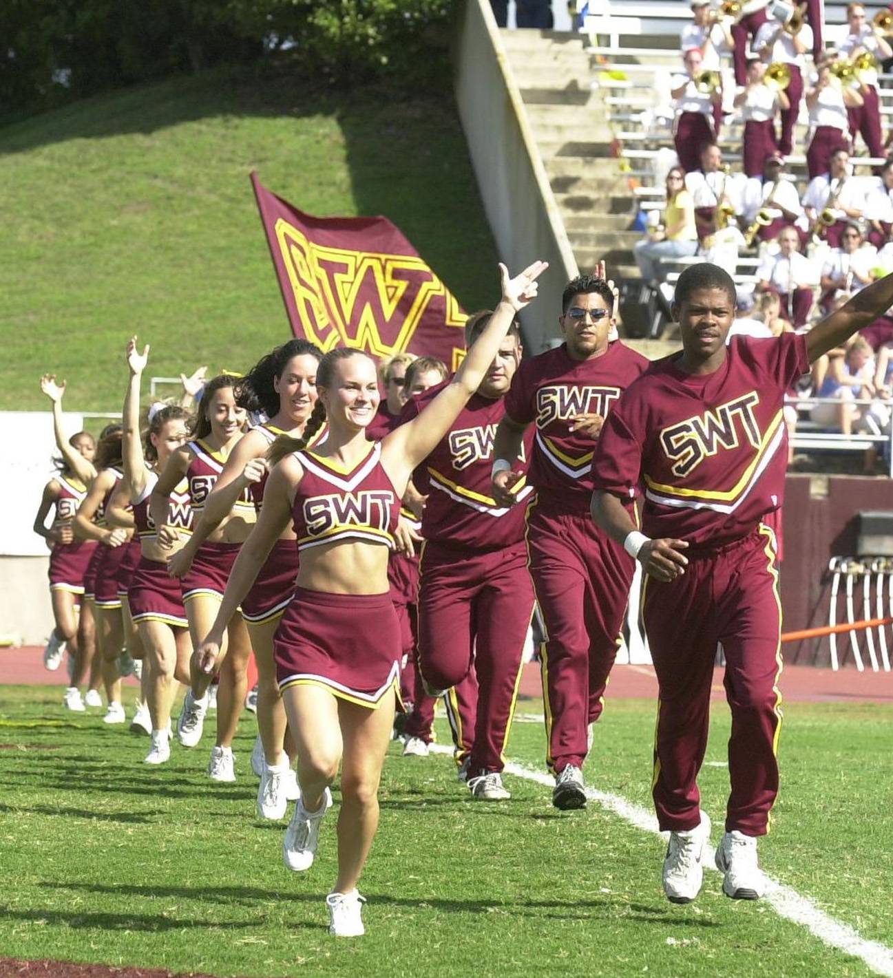 cheerleaders running onto field