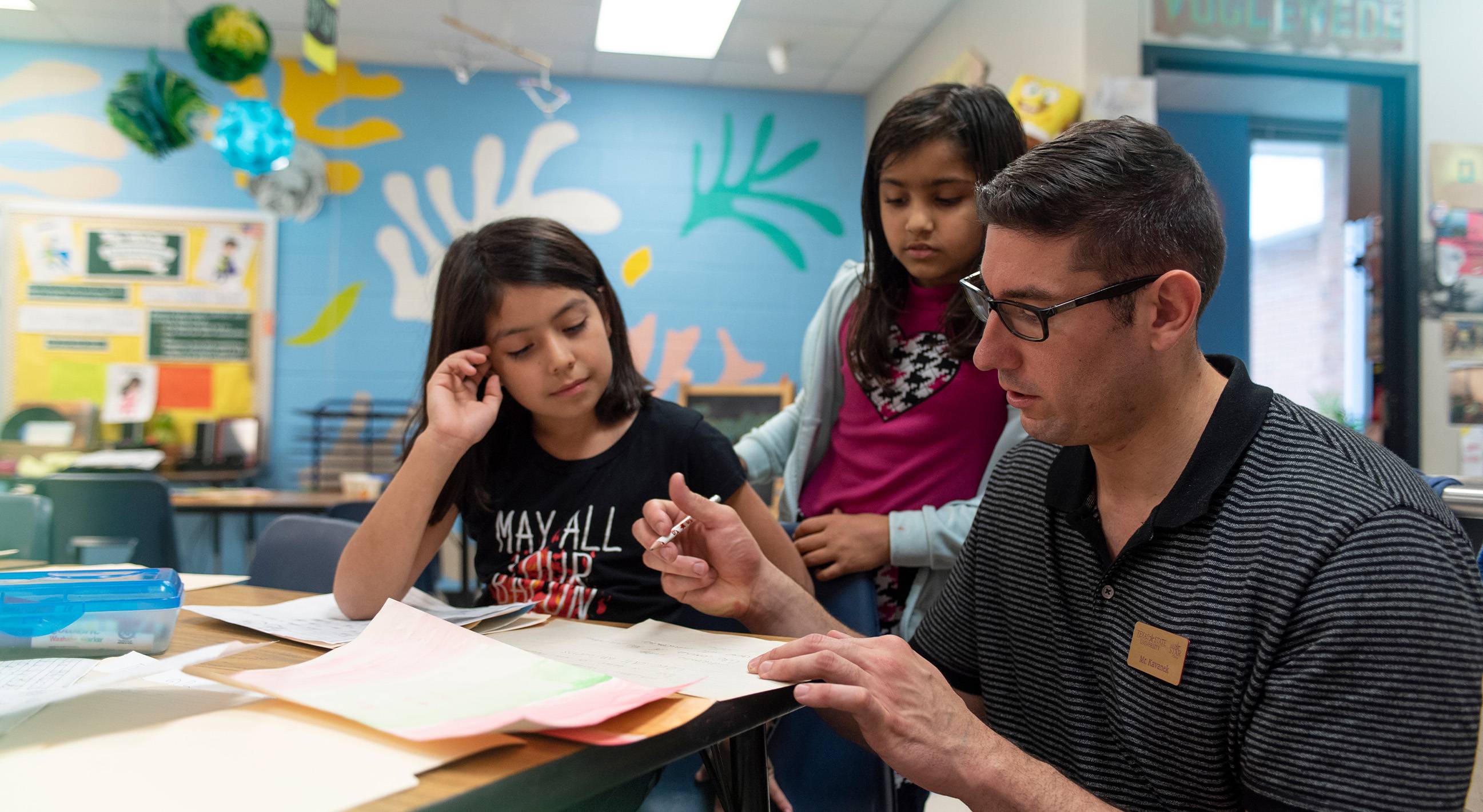 teacher working with 2 young children