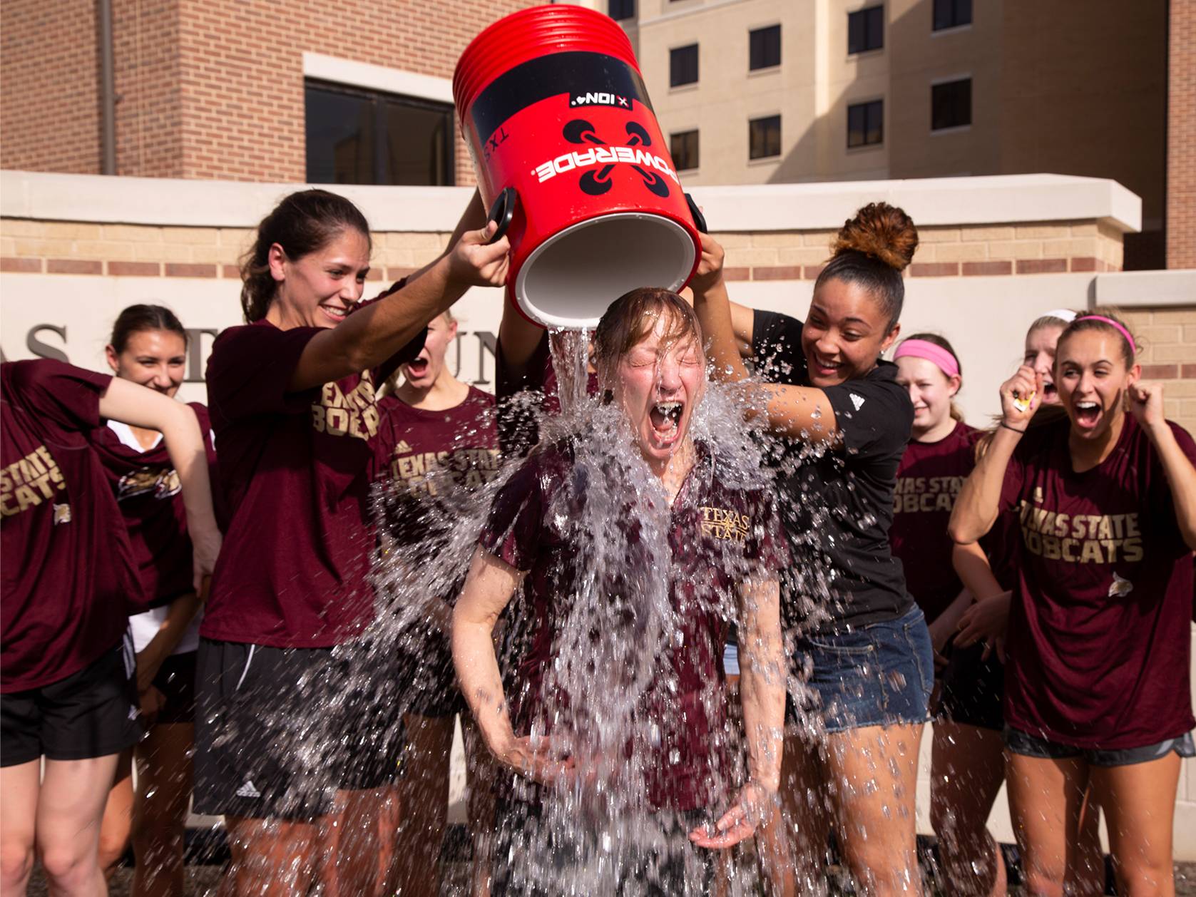 students dumping bucket of water on dr trauth 