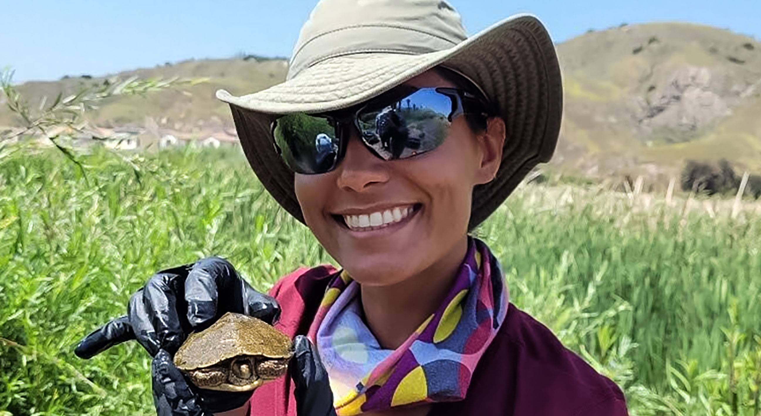 women holding small turtle