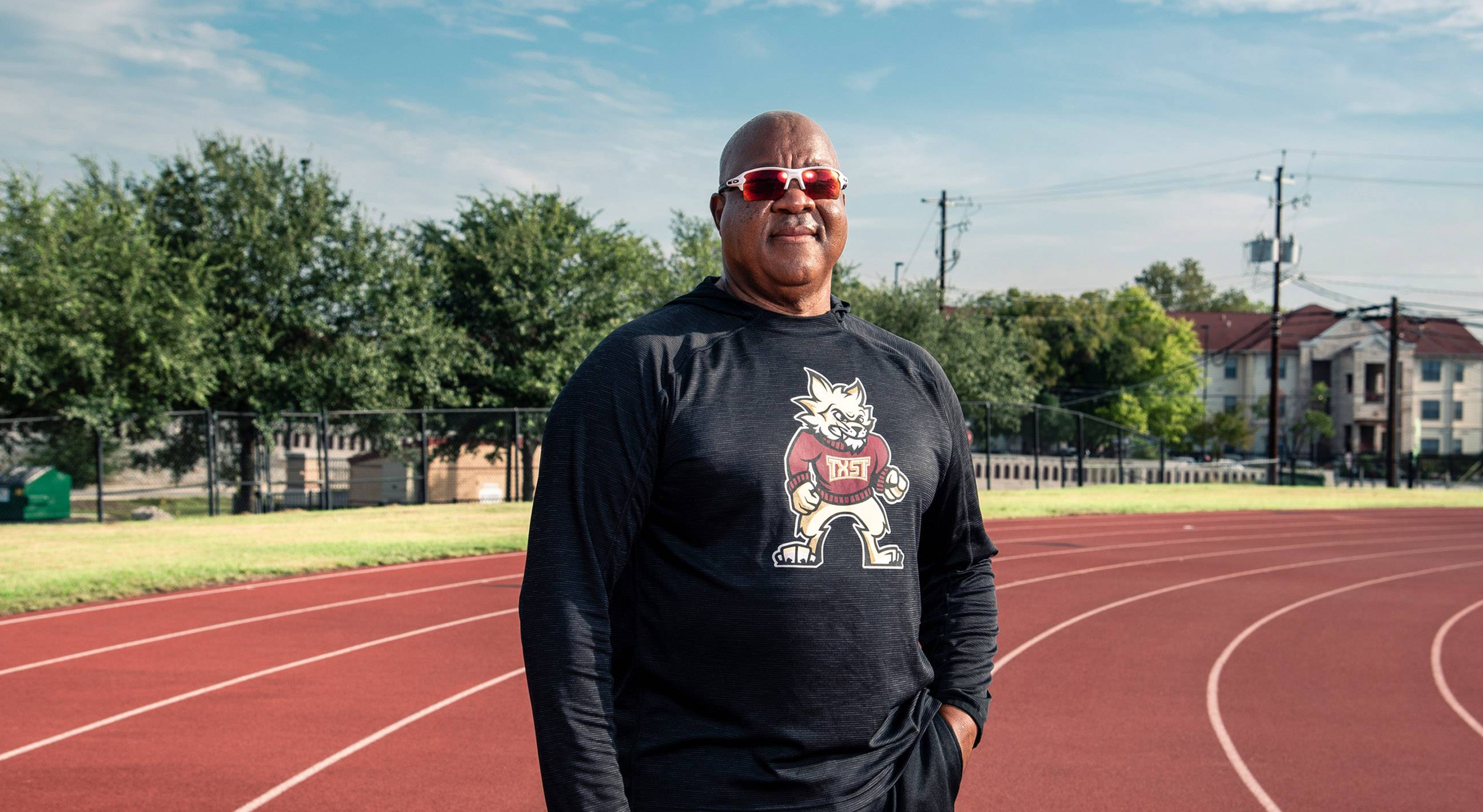 coach frazier smiling standing on track