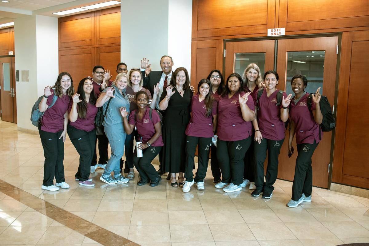 kelly and beth damphousse posing with large group of nursing students