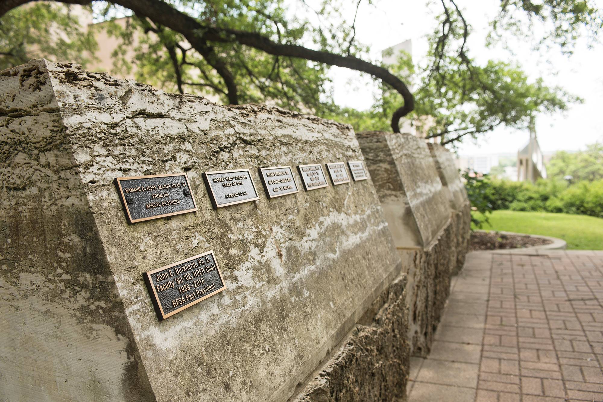 Plaques bearing the names of Bobcats who have passed are mounted on stone tablets.