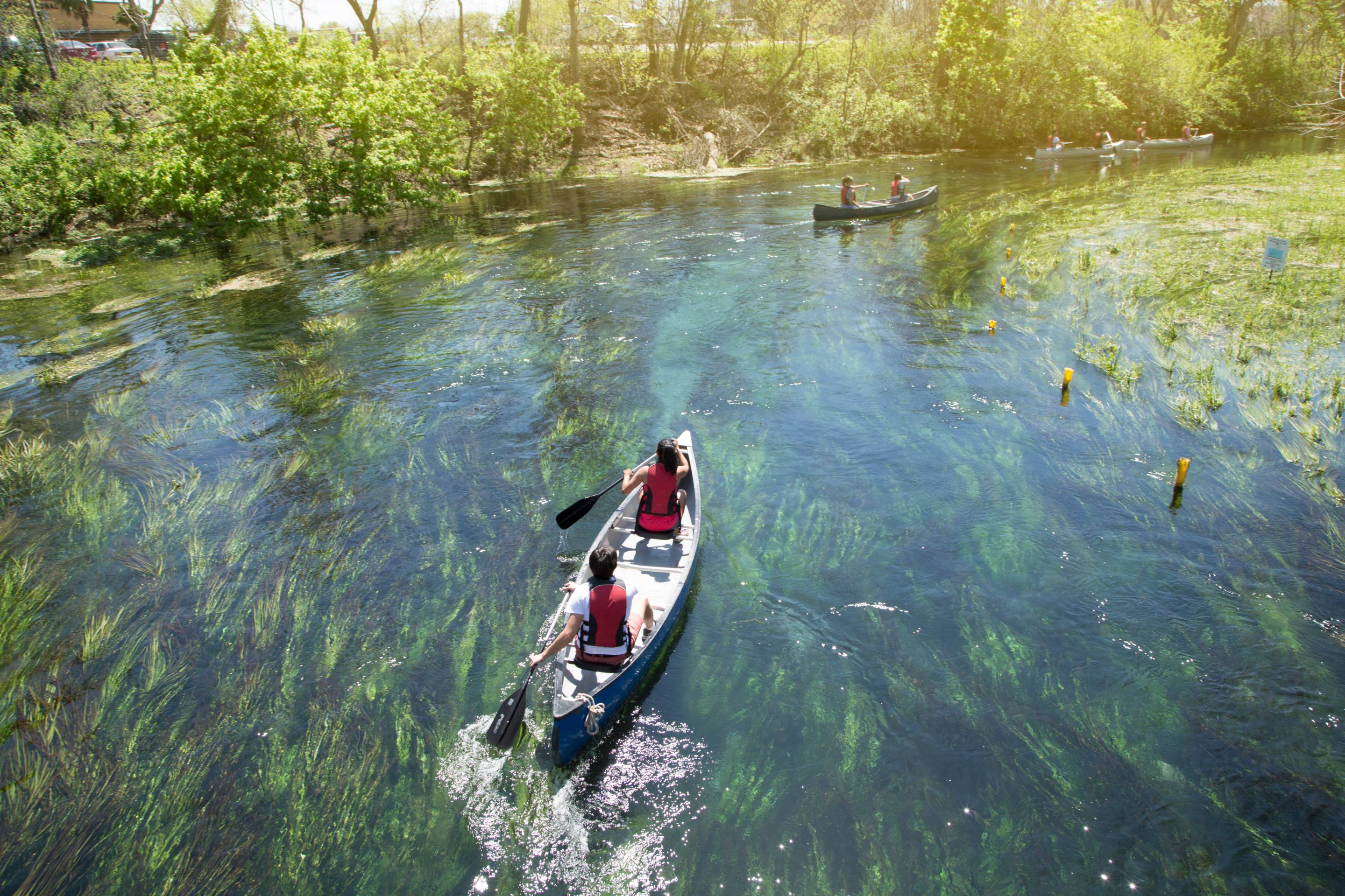 two men in a canoe on the san marcos river
