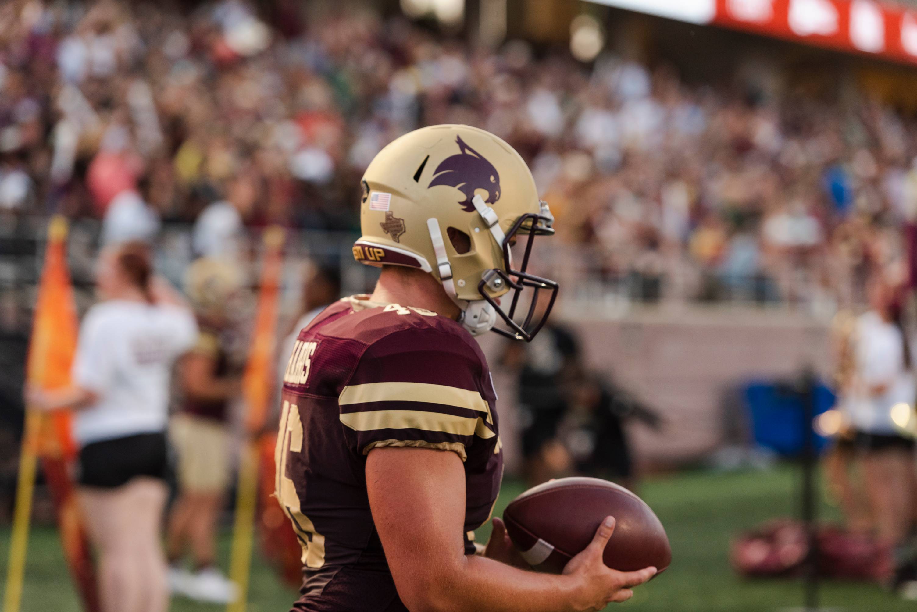 Football player in official TXST uniform