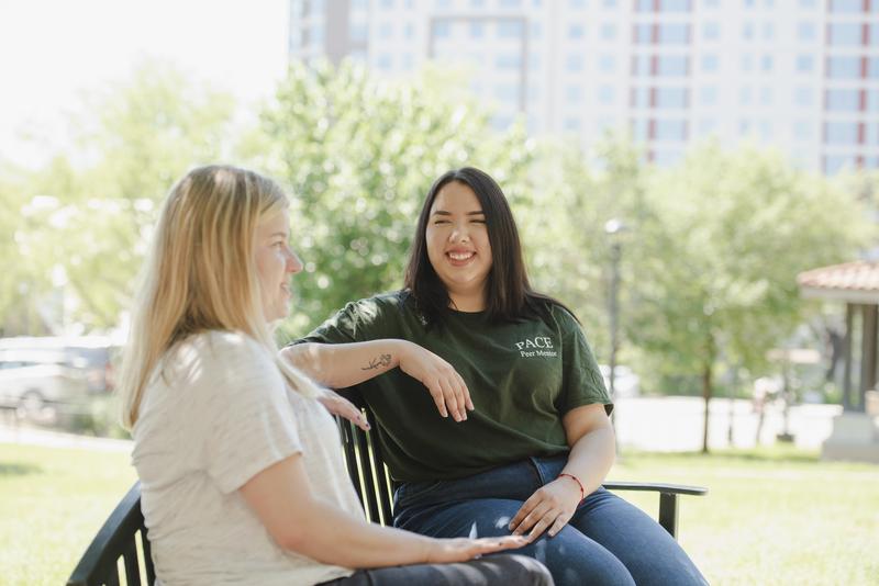 peer mentor sits with student