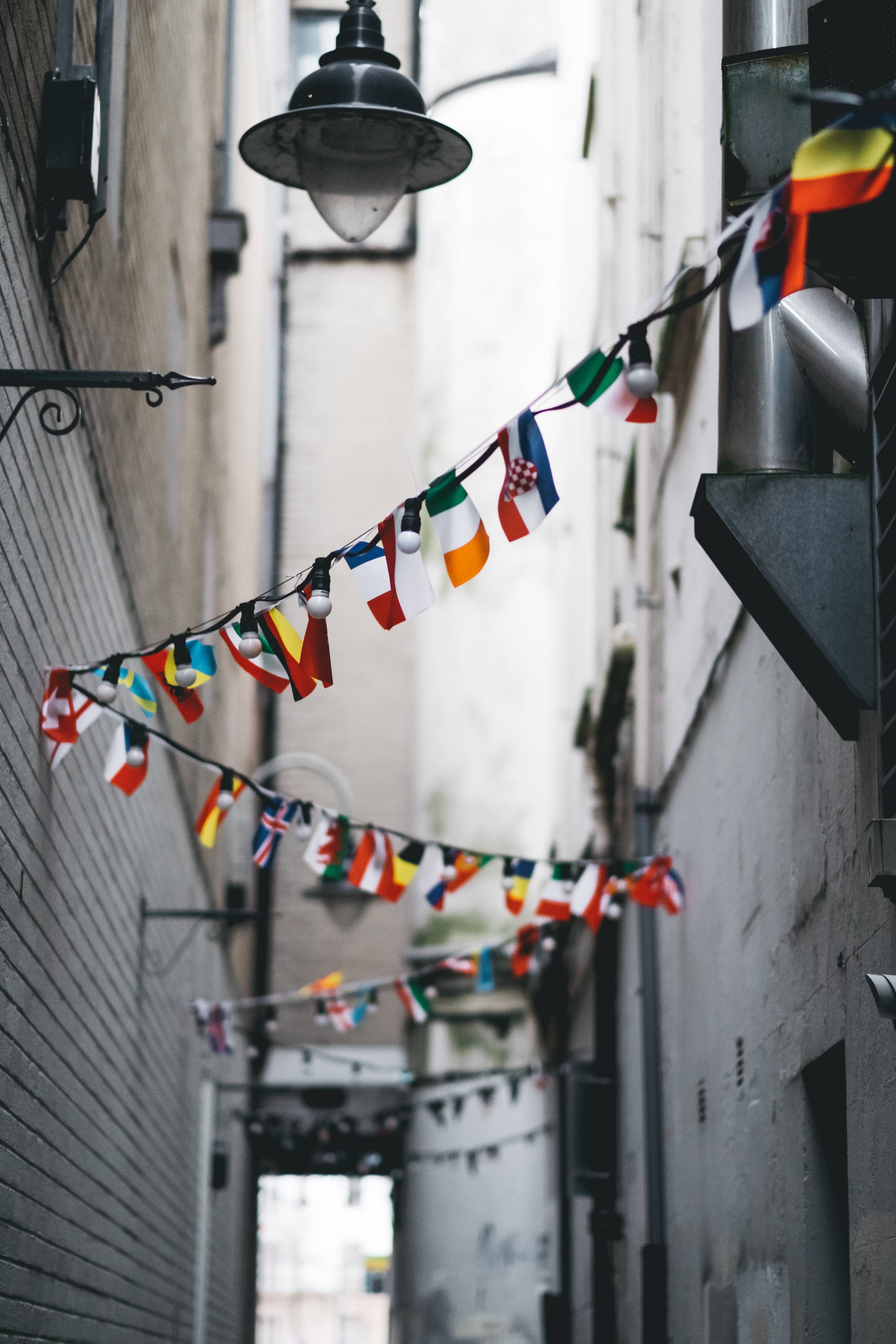 international flags hanging in alley