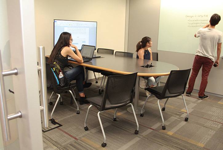 collaboration study room with students inside working on group project