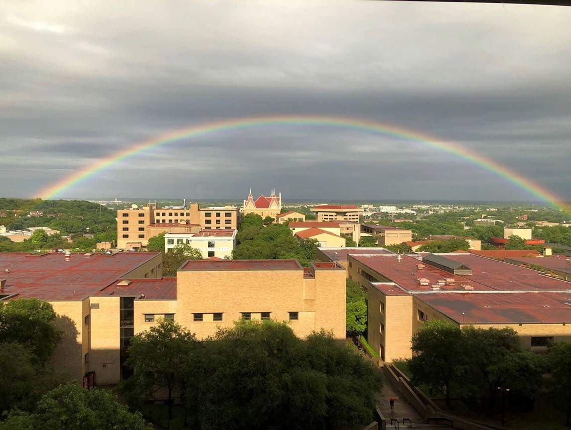 View of a rainbow over Old Main from Alkek Library