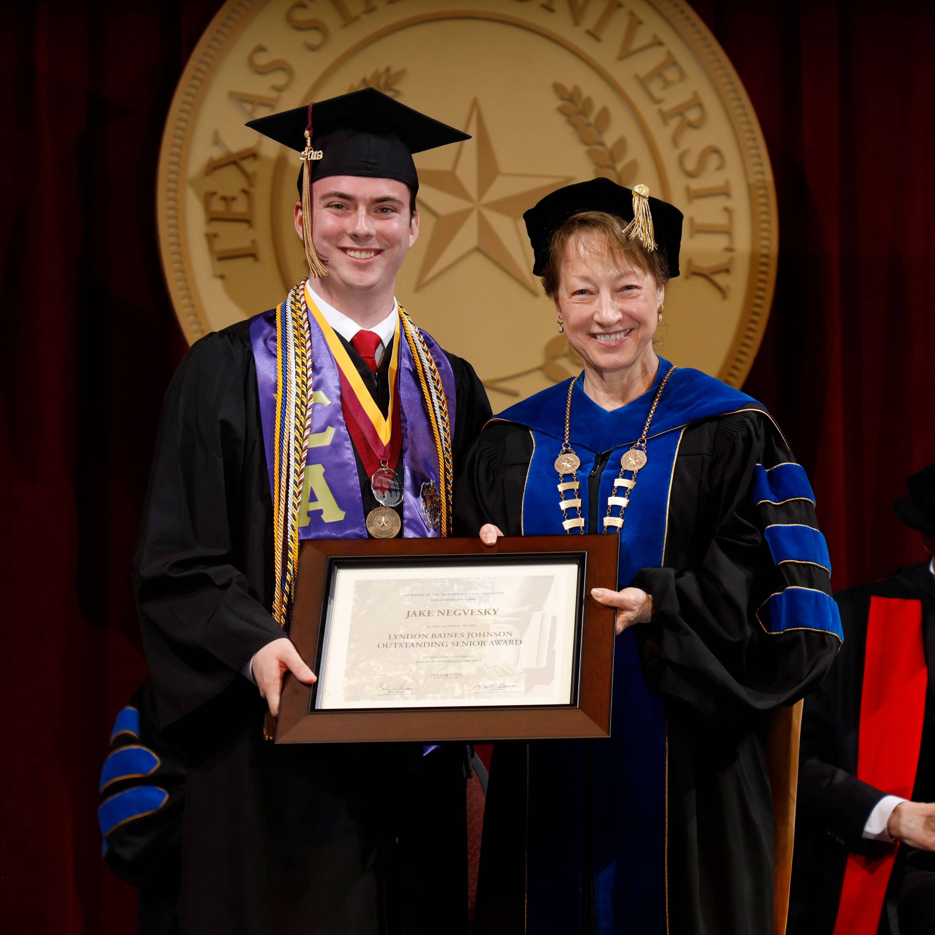 Jake Negvesky and President Denise Trauth at Commencement