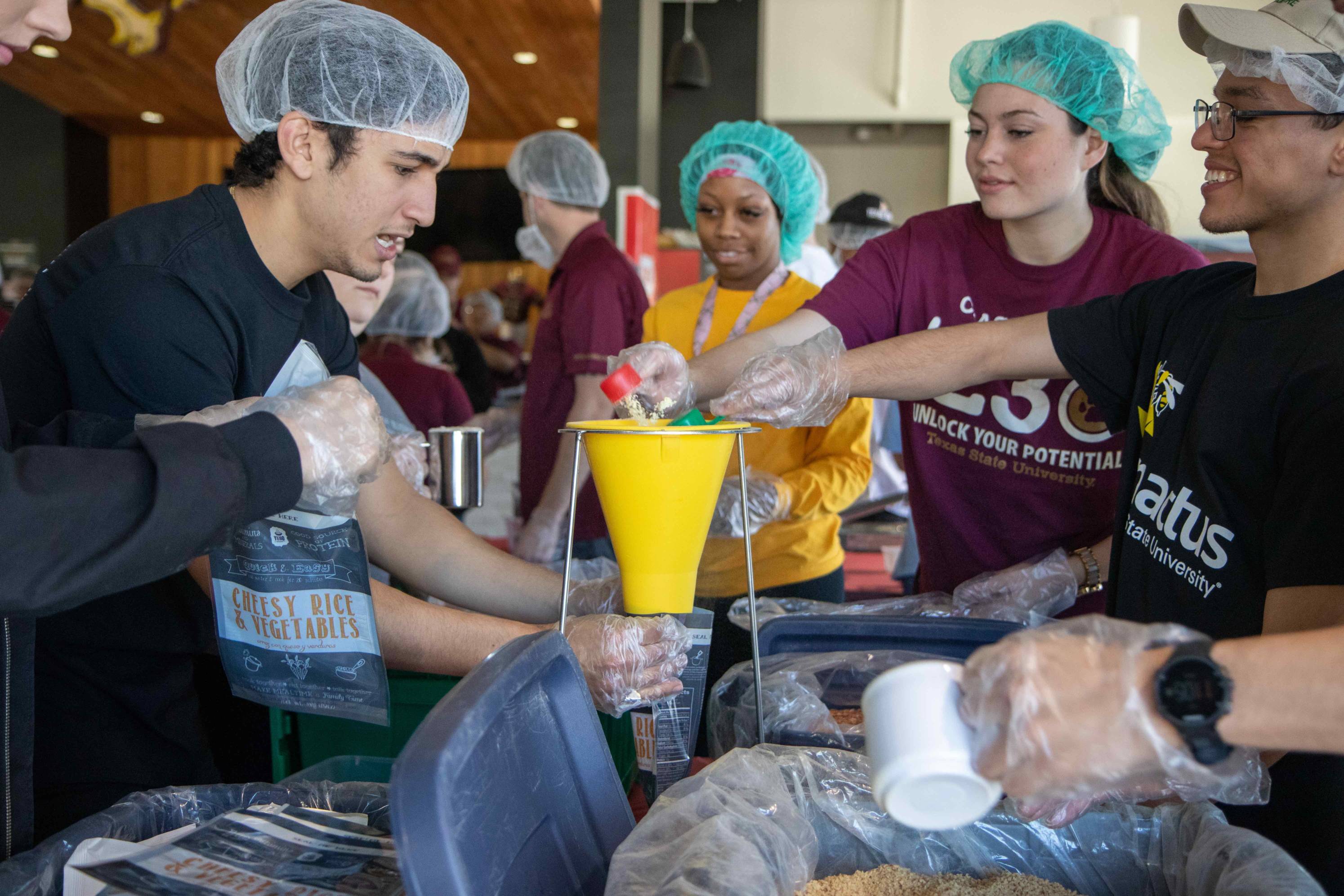McCoy College students packing food