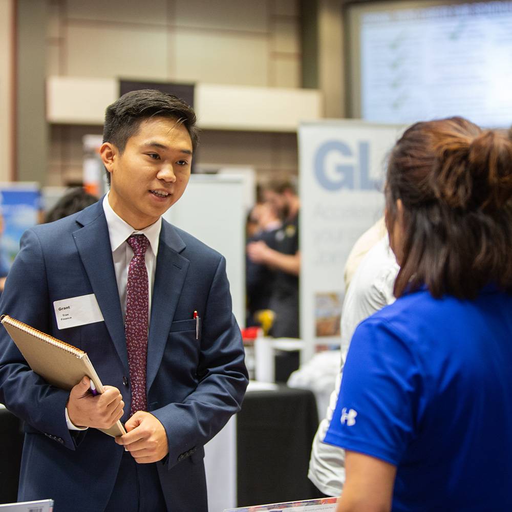 Student talking to recruiter at career fair